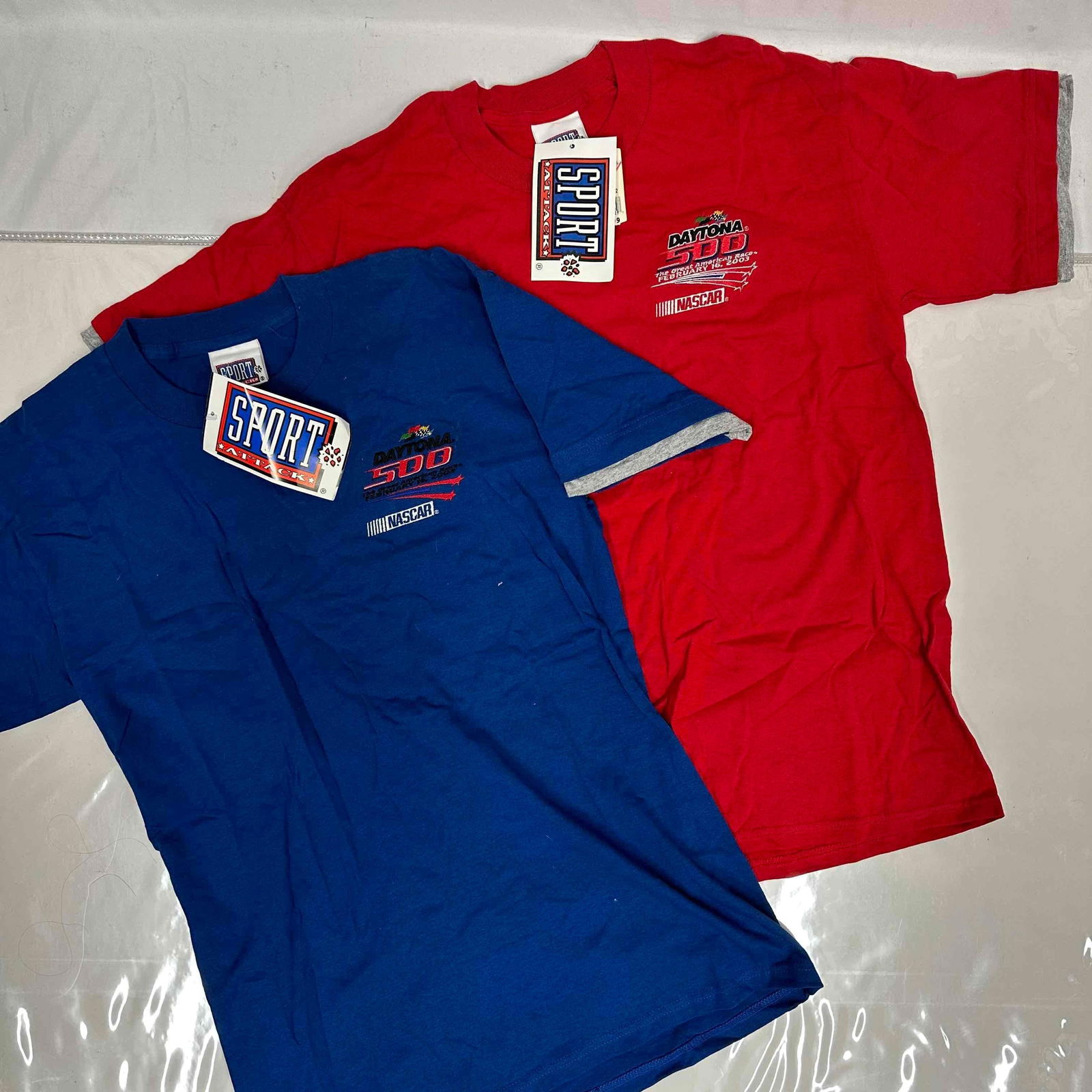 Daytona 500 NASCAR Sport Attack Red and Blue T-Shirt Set: Daytona 500 NASCAR Sport Attack Red and Blue T-Shirt Set. Size Medium. These items are in like new, previously displayed condition with light wear, and original tag is still intact. Please reference a