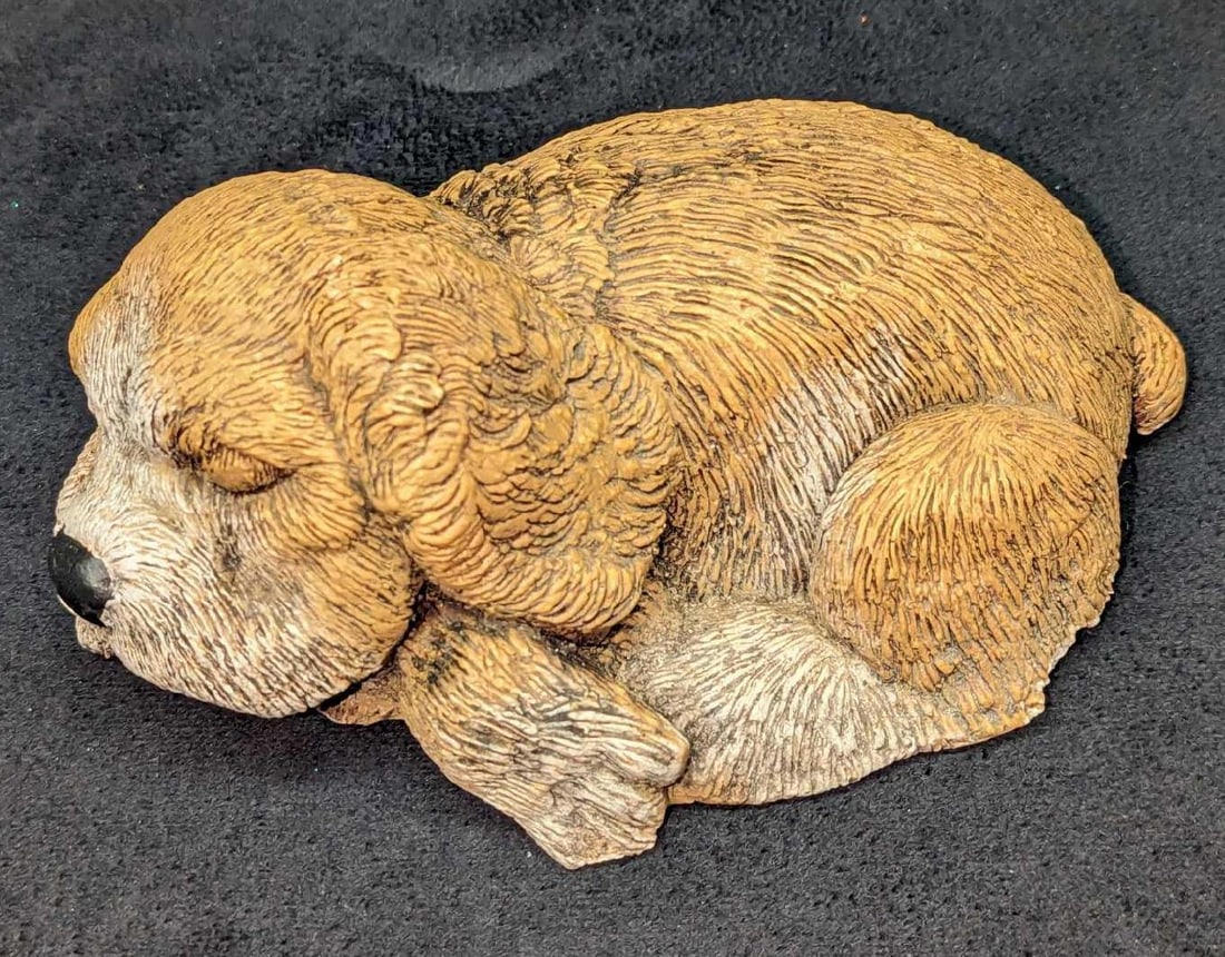 SM 1987 Sleeping Puppy Figurine: SM 1987 Sleeping Puppy Figurine. Appears to be either made of plaster or a Sandicast type material. This is approx 6" x 4" x 2" and it weighs 0.78lb. The figurine has some chips on the bottom edg