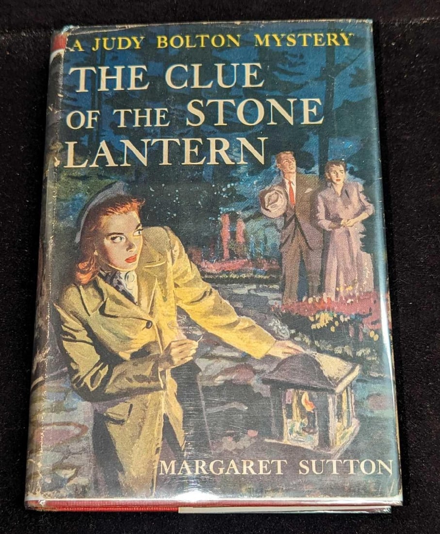 1st Ed Judy Bolton The Clue Of The Stone Lantern HC #21: 1st Ed Judy Bolton The Clue Of The Stone Lantern HC #21. "A Judy Bolton Mystery - The Clue Of The Stone Lantern". By Margaret Sutton (The pen name of Rachel Beebe) and was published by Grosset & Dunla