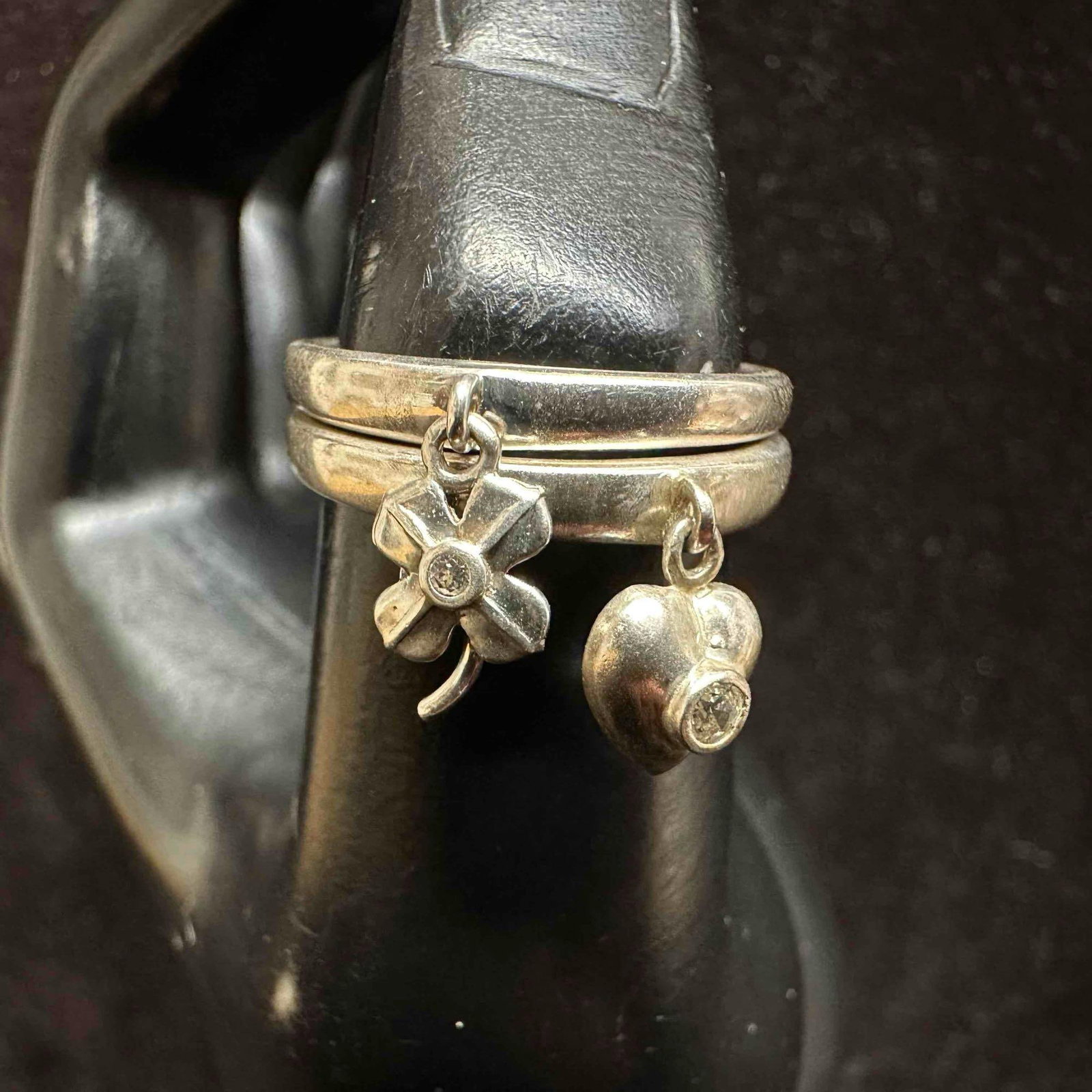 Four-Leaf Clover and Heart Charm Dangle Cubic Zirconia Sterling Silver Ring Set: These items are in good pre-owned, previously used/displayed condition with noticeable light wear, and surface scratches. Please reference all photos for full details. These pieces of jewelry have bee