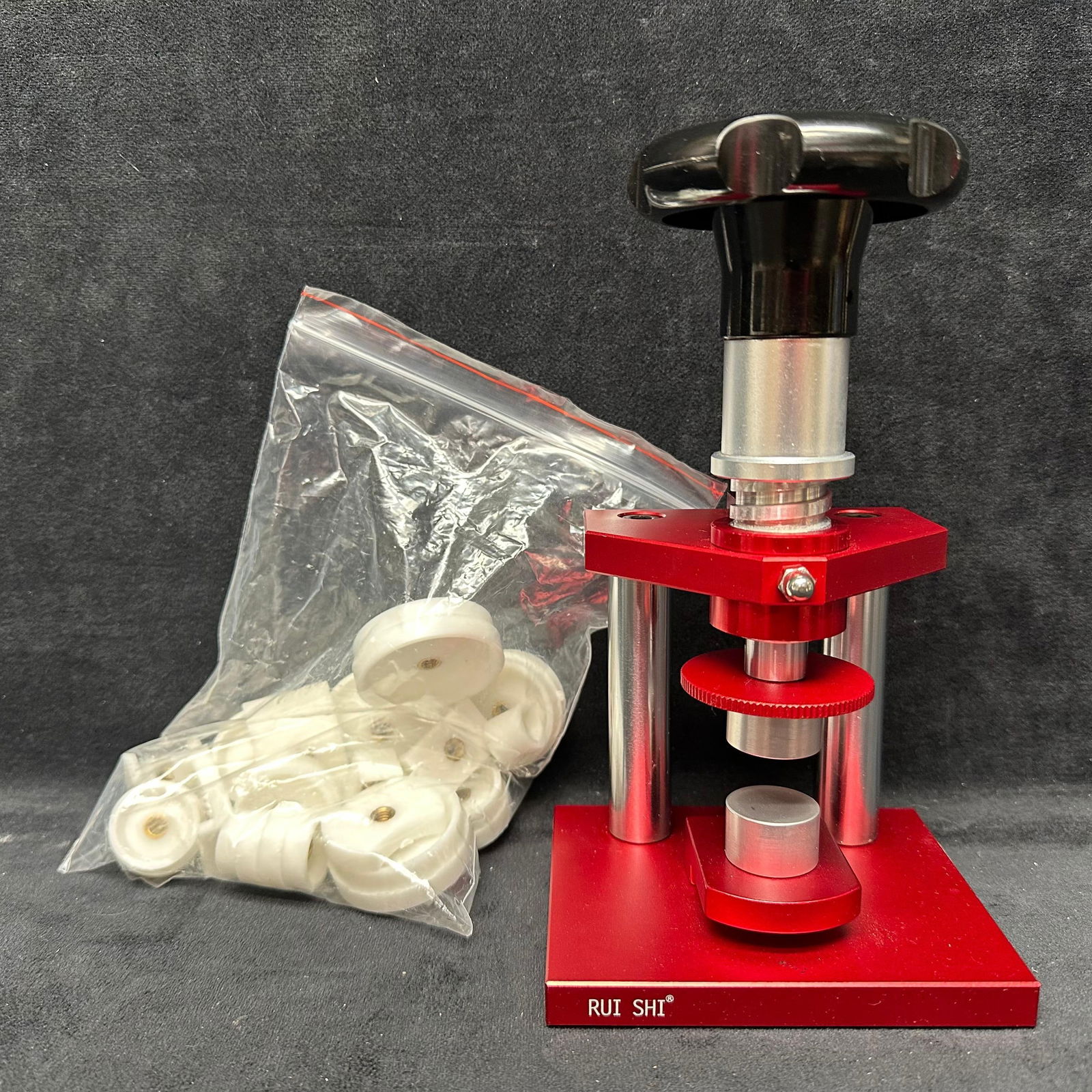 Rui Shi Watch Case Press Tool With Dies Repair Watchmaker: Rui Shi watch case press tool with assorted plastic dies. Heavy-duty metal construction with adjustable press action. Includes a bag of multiple die sizes for a variety of watch backs. Pre-owned in