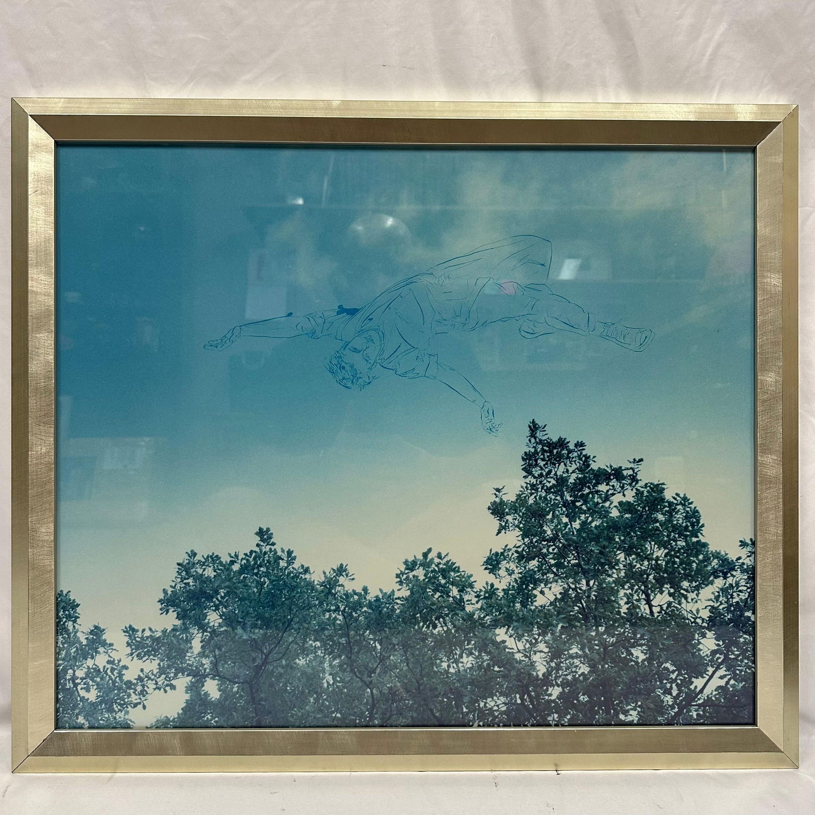 Mixed Media Sky Figure Outline Line Contemporary Art Framed Surreal Scene: Framed contemporary mixed-media artwork featuring a soft blue sky with silhouetted treetops and a lightly sketched floating male figure above. The piece blends photography with line drawing to create