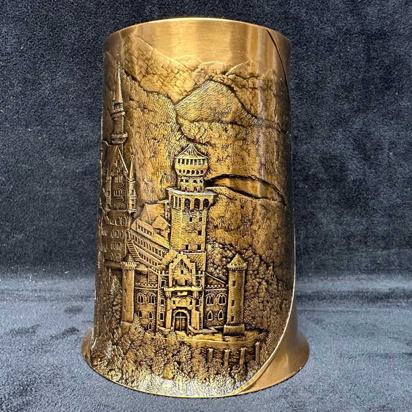 Wendell August Forge Solid Bronze Castle Tankard Handmade: Solid bronze tankard by Wendell August Forge featuring a detailed relief depiction of Neuschwanstein Castle. Handmade in Grove City, Pennsylvania. Includes curved handle and fully embossed scenic desi