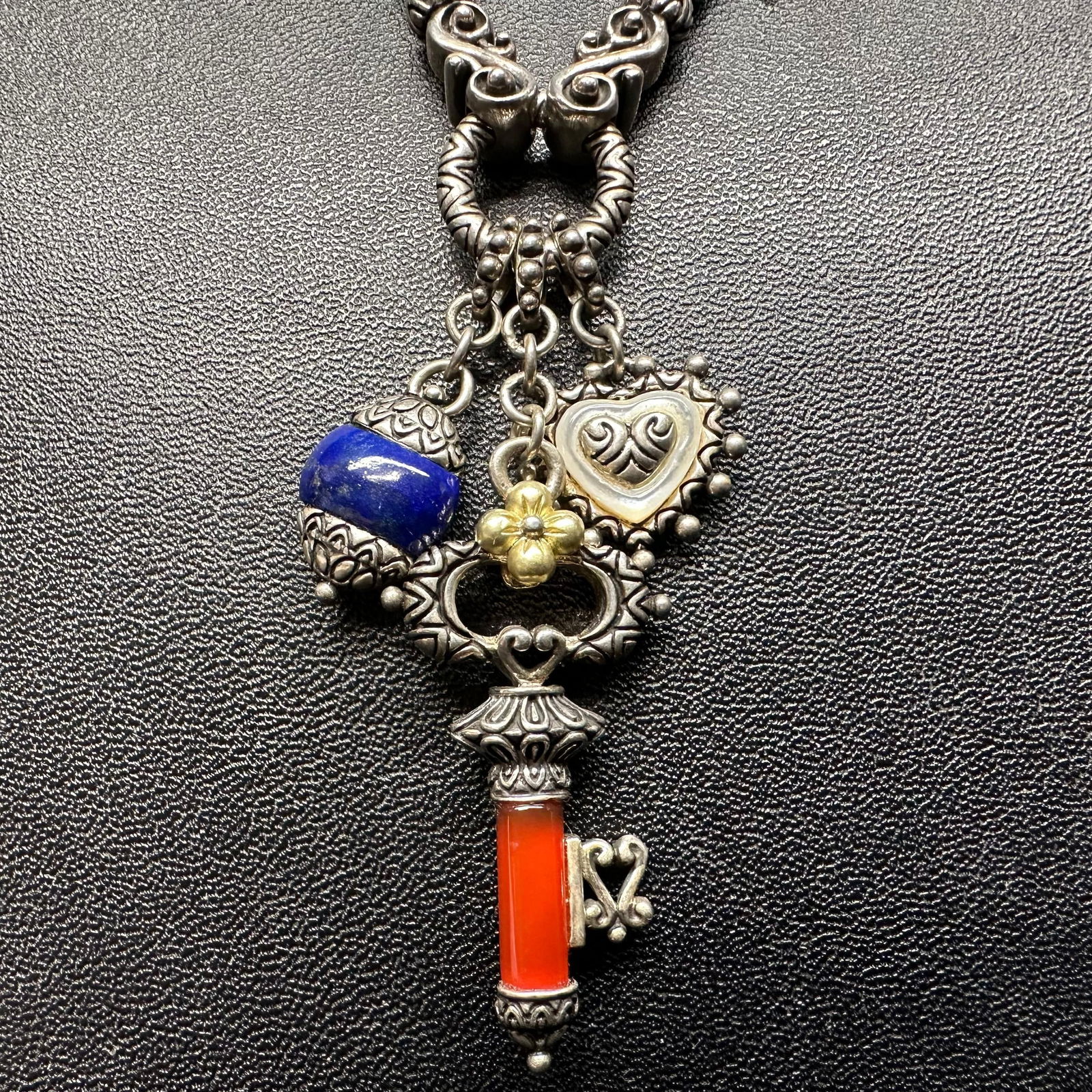 Barbara Bixby Lapis Carnelian 18K Gold Sterling Silver Multi Charm Pendant Necklace: This item is in good pre-owned, previously used/displayed condition with noticeable light wear, and surface scratches. Please reference all photos for full details. This piece of jewelry has been test