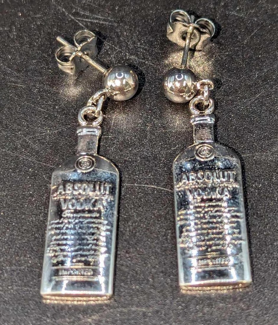 Rare Absolut Vodka Silver Plated Earrings? C: Rare Absolut Vodka Silver Plated Earrings? C. Each is approx 1 3/4" x 1/4" and it weighs 5.8g. Both are in an unused condition with no known damage. Please see the images as they are part of the descr