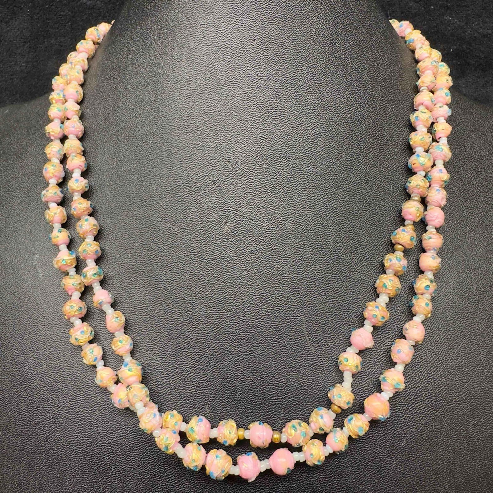 Murano Venetian Art Glass Lamp Work Pink Small Beaded Long Necklace D22: Murano Venetian Art Glass Lamp Work Pink Small Beaded Long Necklace D22. Necklace with pink glass beads with beautiful designs on each. The necklace features green colored accents. The necklace featur