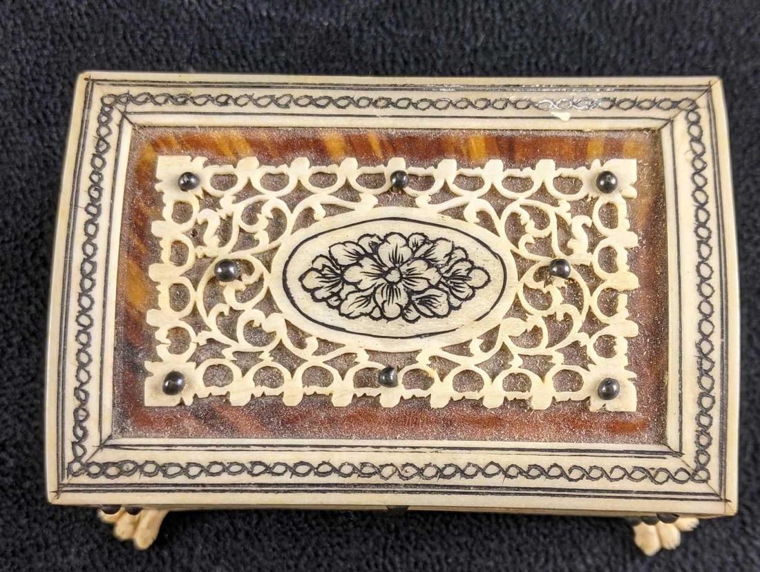 Rare Trinket Wooden Box With Carved Bone Detailing: Rare Trinket Wooden Box With Carved Bone Detailing This beautiful box is wooden with rare bone-carved detailing and feet. This bone is a retired material that has been hand carved intricately. There a