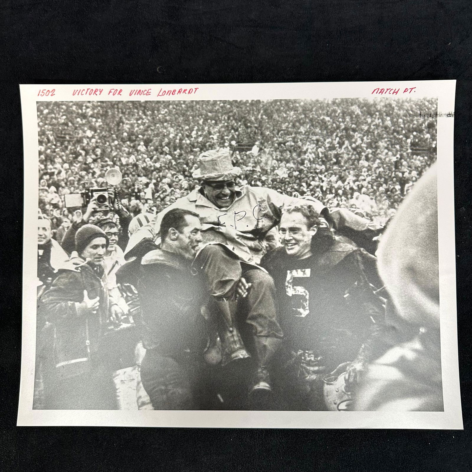 Black and White Silver Gelatin Print Vince Lombardi Victory Celebration: Black and white analog photo print depicting legendary coach Vince Lombardi being carried on the shoulders of jubilant Green Bay Packers players after a victory. The image captures the energy and triu