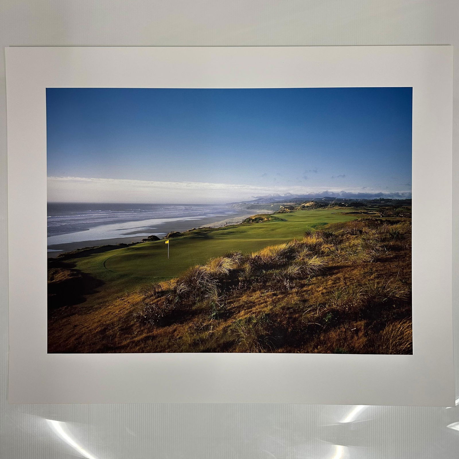 Color Coastal Golf Course Photography Print Bandon Dunes Oregon: High-quality color photographic print depicting a dramatic seaside golf course, most likely from the renowned Bandon Dunes Golf Resort on the Oregon coast. The image captures a scenic fairway and gree