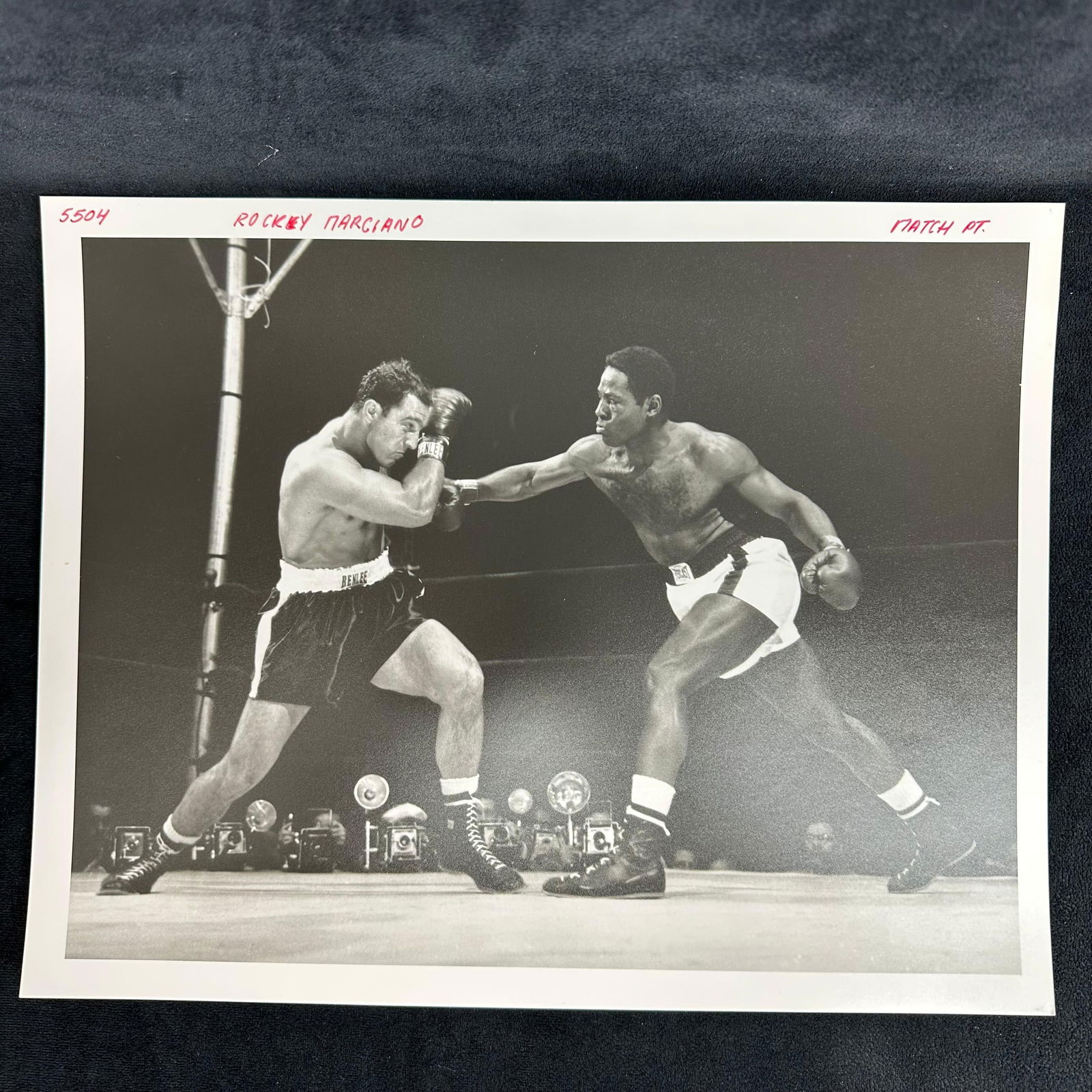 Rocky Marciano and Ezzard Charles Analog Black and White Photograph Print Boxing Photo: Black and white analog photograph print capturing the legendary heavyweight bout between Rocky Marciano and Ezzard Charles. Printed on pearl resin-coated photo paper with red ink notations at the top