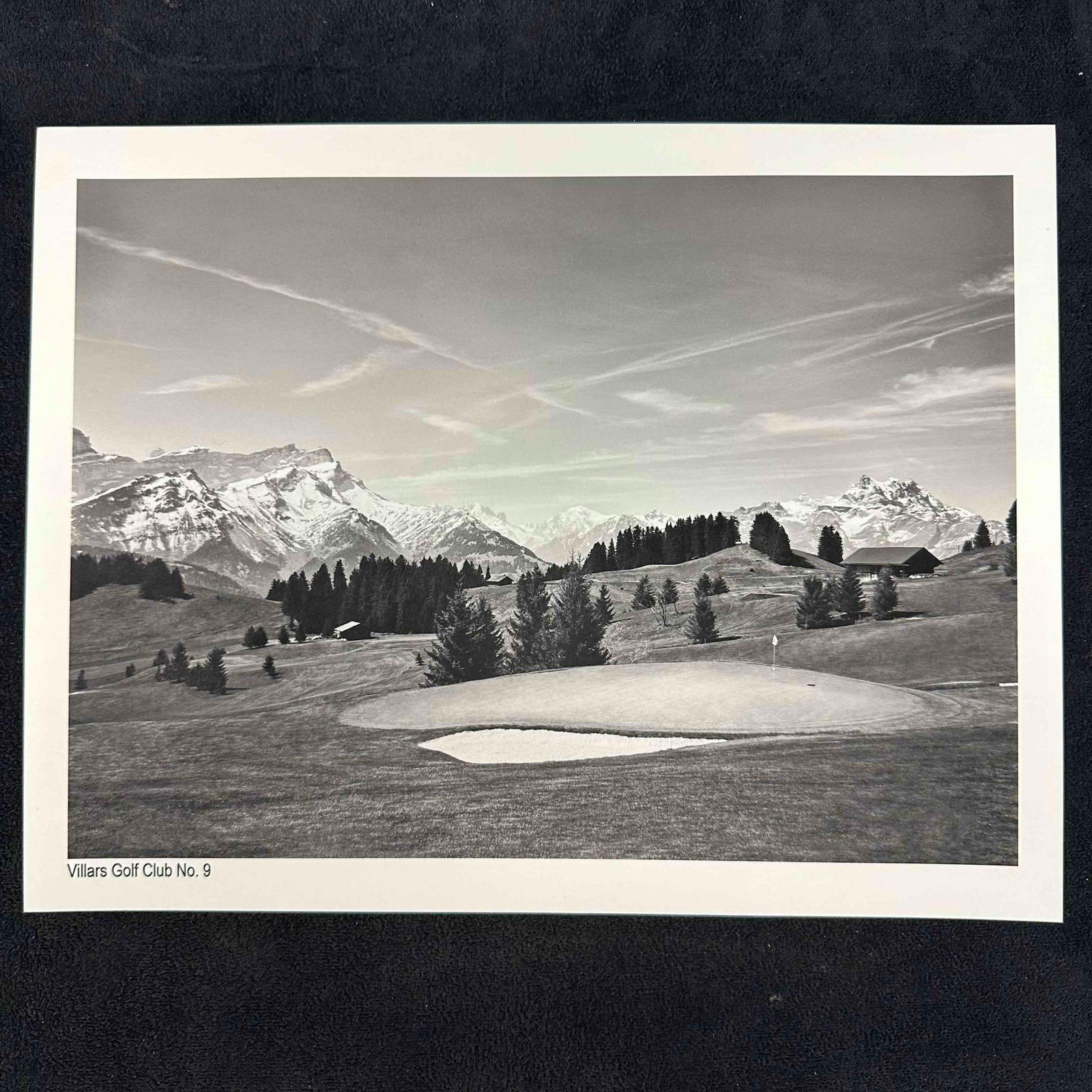 Villars Golf Club No. 9 Black and White Fine Art Photography Print: Black-and-white photograph of Villars Golf Club’s 9th hole, set against the breathtaking backdrop of the Swiss Alps. The image highlights the serene fairway, surrounding trees, and distant snow-capp