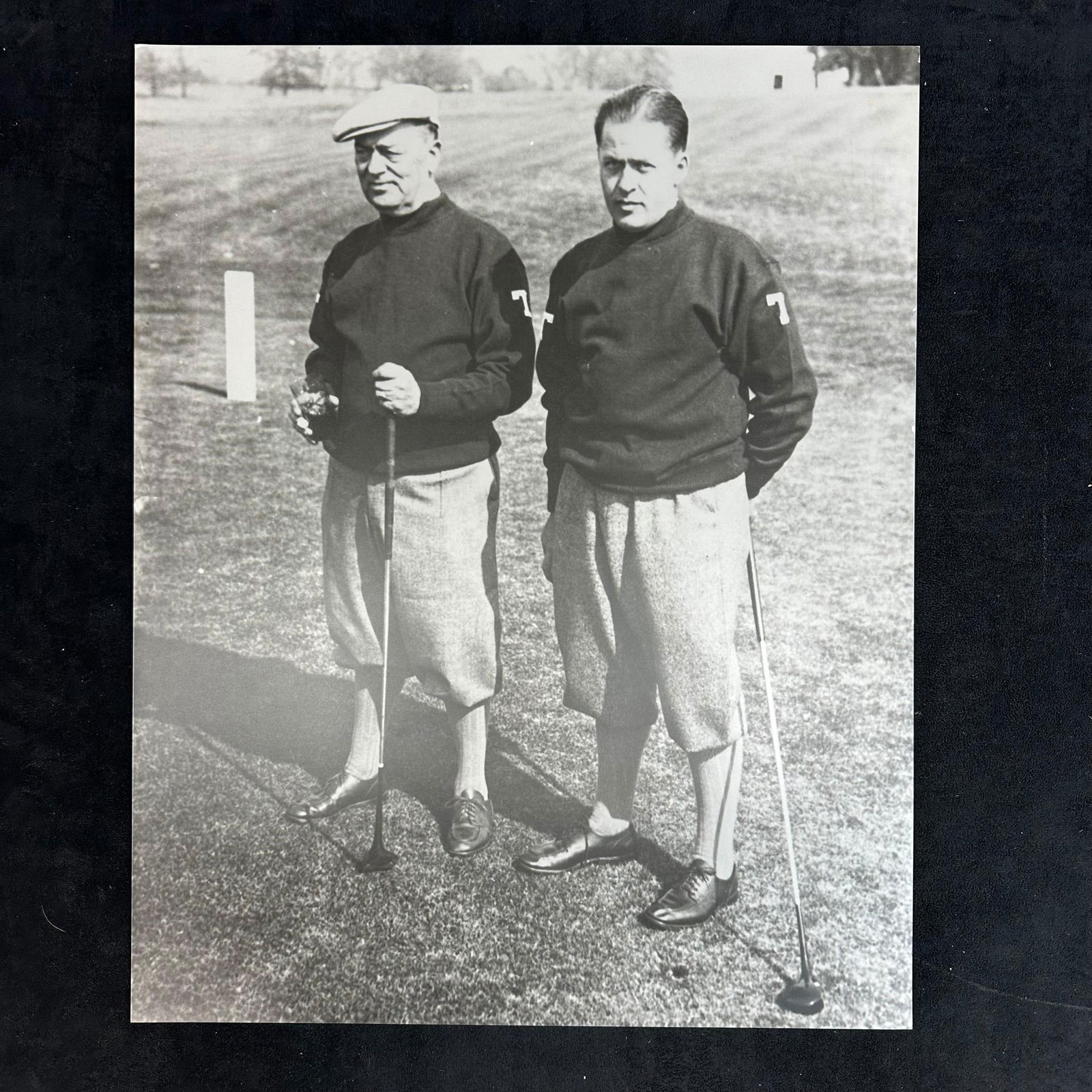 Black and White Golf Photographic Print Bobby Jones and Colonel Robert P. Jones Portrait #2: Vintage style black and white photograph print capturing legendary golfer Bobby Jones alongside his father, Colonel Robert P. Jones, on the course. The image showcases both men dressed in traditional
