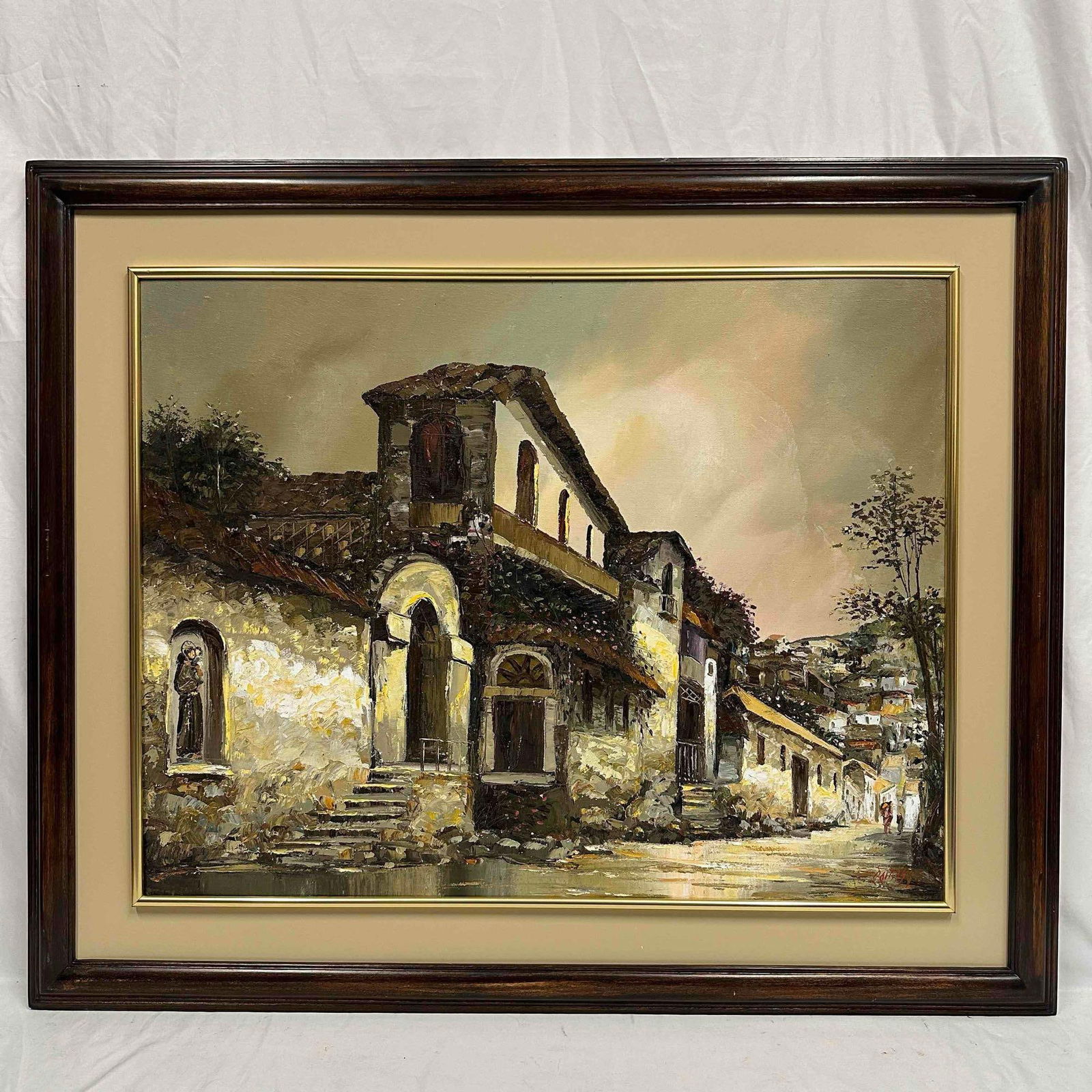 Acrylic Large Painting Framed Artwork Old Town Street Scene R152: This acrylic painting depicts an old town street scene. The painting shows a cluster of buildings with textured wall and a central structure featuring a prominent arched doorway. Unknown artist signat