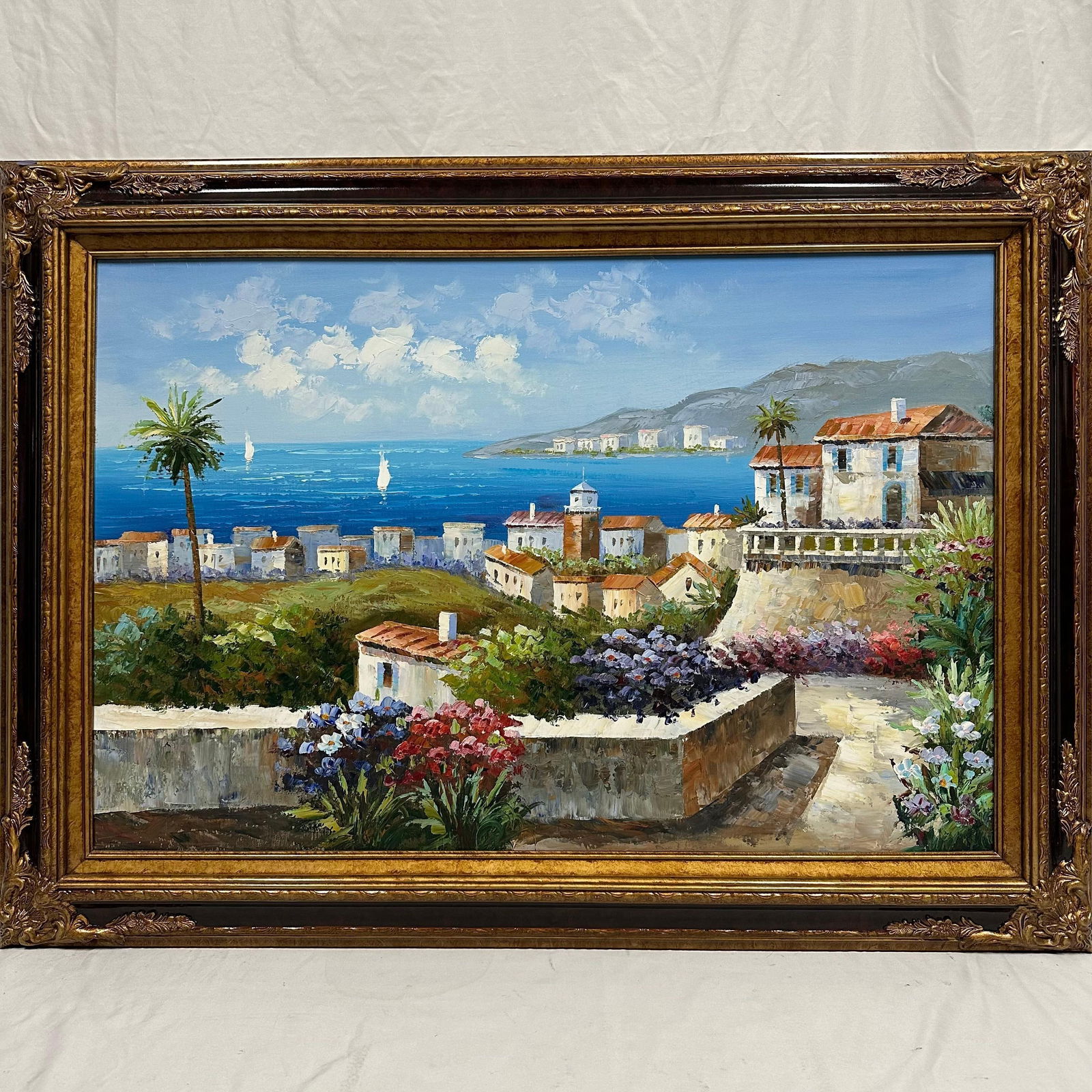 Large Mediterranean Coastal Village Oil Painting Original Artwork in Ornate Burgundy Wood Frame: Beautiful original oil painting on canvas depicting a vibrant Mediterranean-style coastal village overlooking the sea. The scene captures terracotta-roofed villas, flowering terraces, and palm trees l