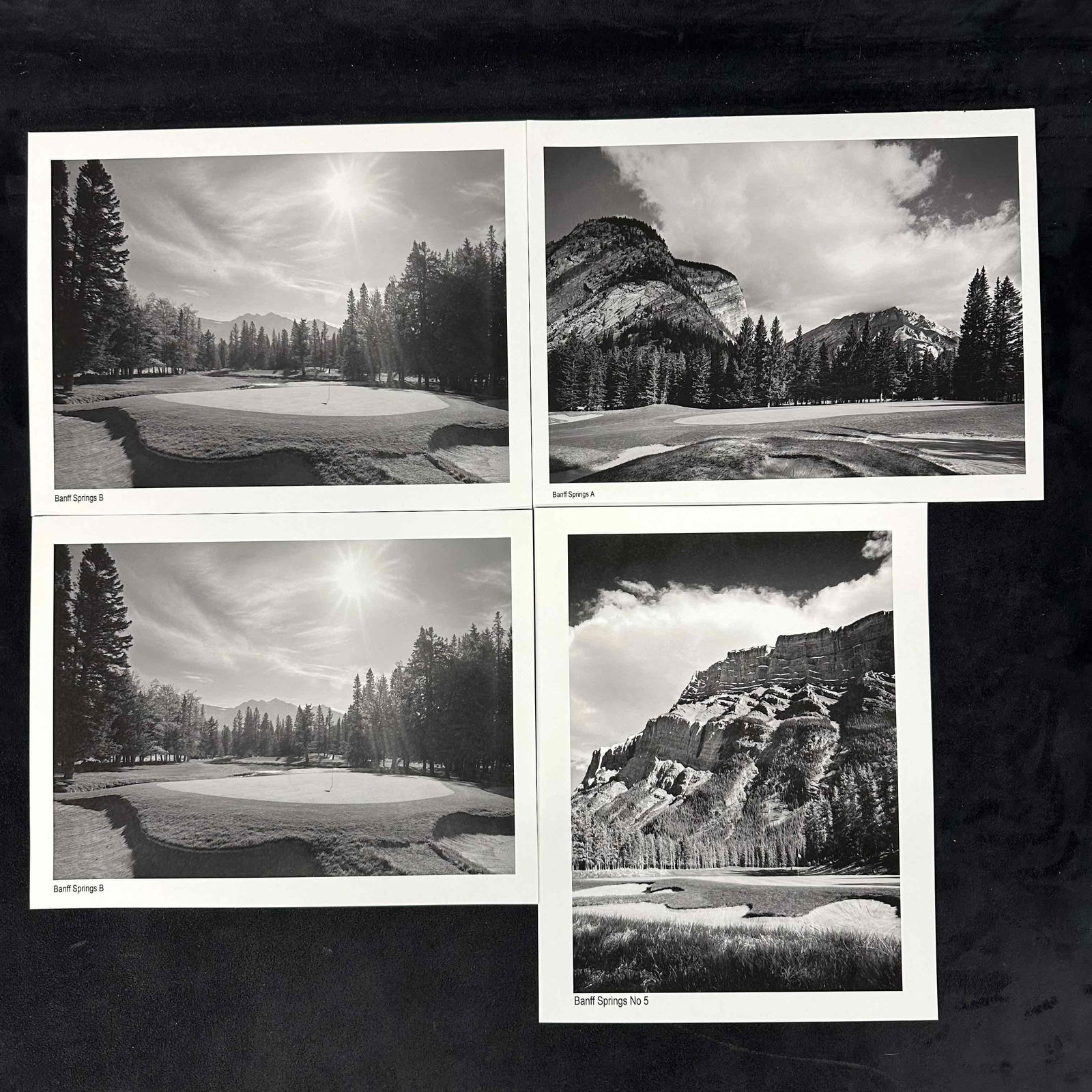 Banff Springs Golf Course Black & White Set of Four Prints: Set of four black and white photographic prints featuring scenic views of Banff Springs Golf Course, including holes No. 5 and others. Each print highlights dramatic mountain backdrops, tree-lined fai