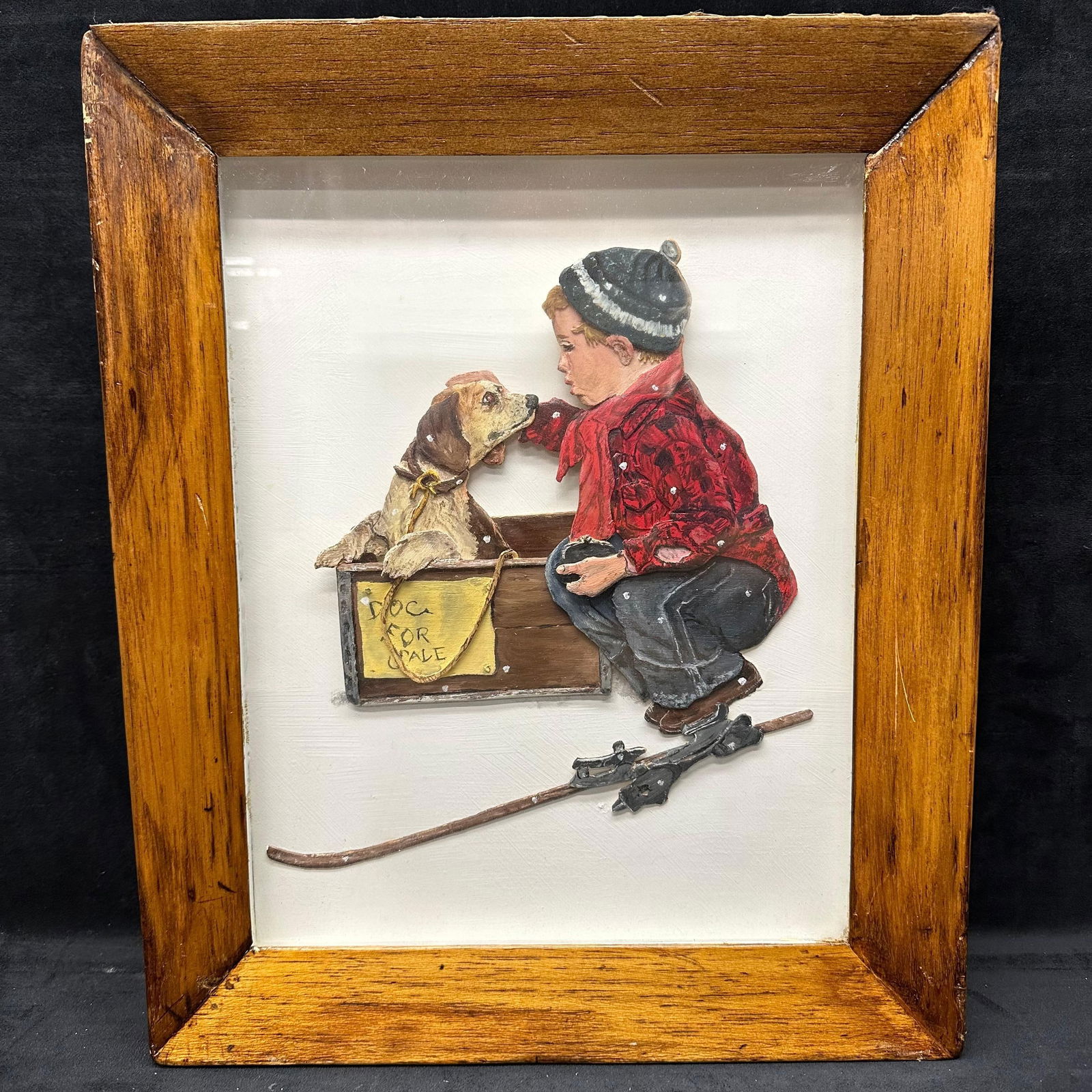 3-D Relief Wall Art Boy and Dog For Sale Scene Shadow Box Type Frame: A vintage 3-D molded relief wall art panel, hand-painted, depicting a young boy kneeling beside a wooden crate labeled “Dog For Sale,” petting a puppy. This mixed media art piece references a