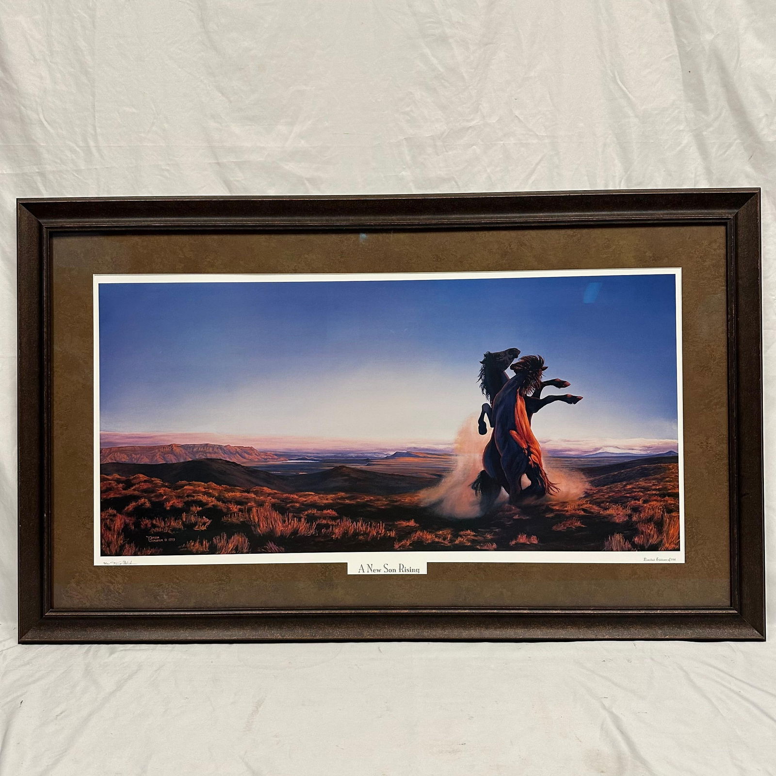 Teresa Schleigh A New Son Rising Signed and Numbered Landscape Horse Art Print: Framed limited edition print titled “A New Son Rising” by artist Teresa Schleigh, dated 1999. Hand-signed and hand-numbered 4/250 in the lower margin. Depicts two horses rearing against a dram