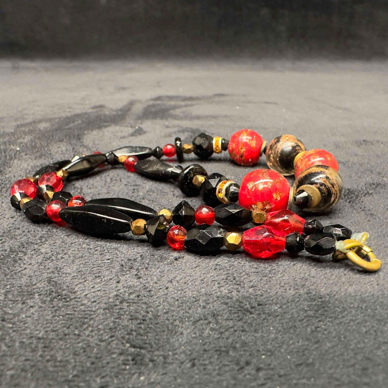 Venetian Murano Glass Lamp Work Black Red Round Bead Beaded Necklace B15: Venetian Murano Glass Lamp Work Black Red Round Bead Beaded Necklace B15. Necklace with red and black glass beads with beautiful designs on each. The necklace features copper colored accents. The neck