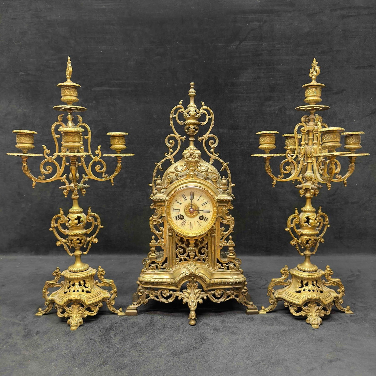 Tiffany and Company Brass Roman Numerals French Baroque Style Mantle Clock Five Light Candelabra Set: Tiffany and Company Brass Roman Numerals French Baroque Style Mantle Clock Five Light Candelabra Set. Marked on the inside backside of the clock Tiffany & Compy 3533. Has not been Tested offering