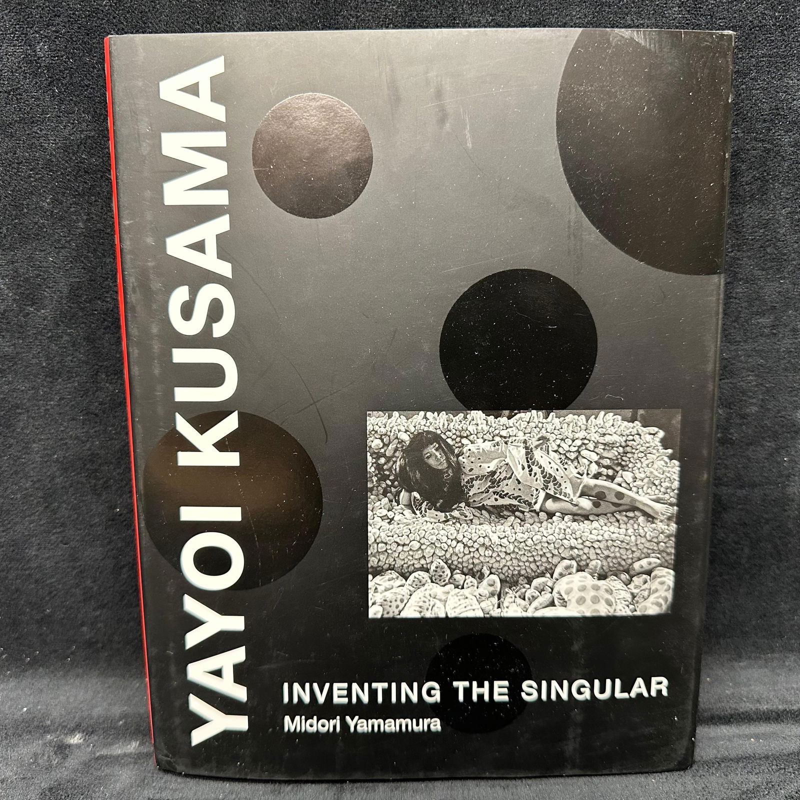 Yayoi Kusama Inventing the Singular Hardcover Midori Yamamura Book: Book includes original dust jacket. This item is in pre-owned, previously displayed condition, with light wear and surface scratches. Please reference all photos for full details. Book: 9 1/4" x