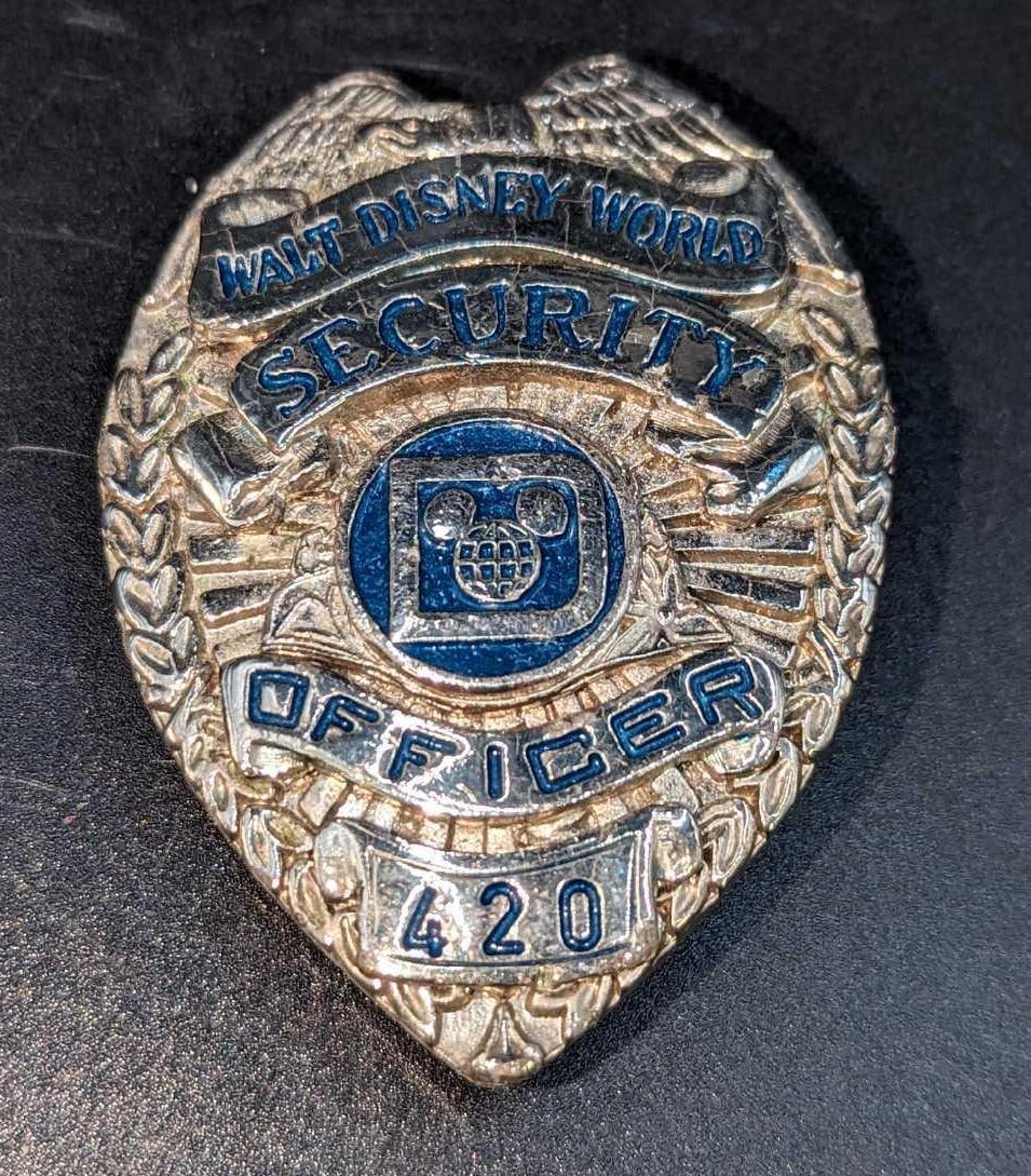 Early 1980s Disney World Female Security Badge: 1970/1980s Disney World Female Security Metal Badge. Is approx 1 1/2" x 3/8" x 2 1/4" and it weighs under one pound at 0.12lb. The metal badge is in good, vintage condition with some light wear and so