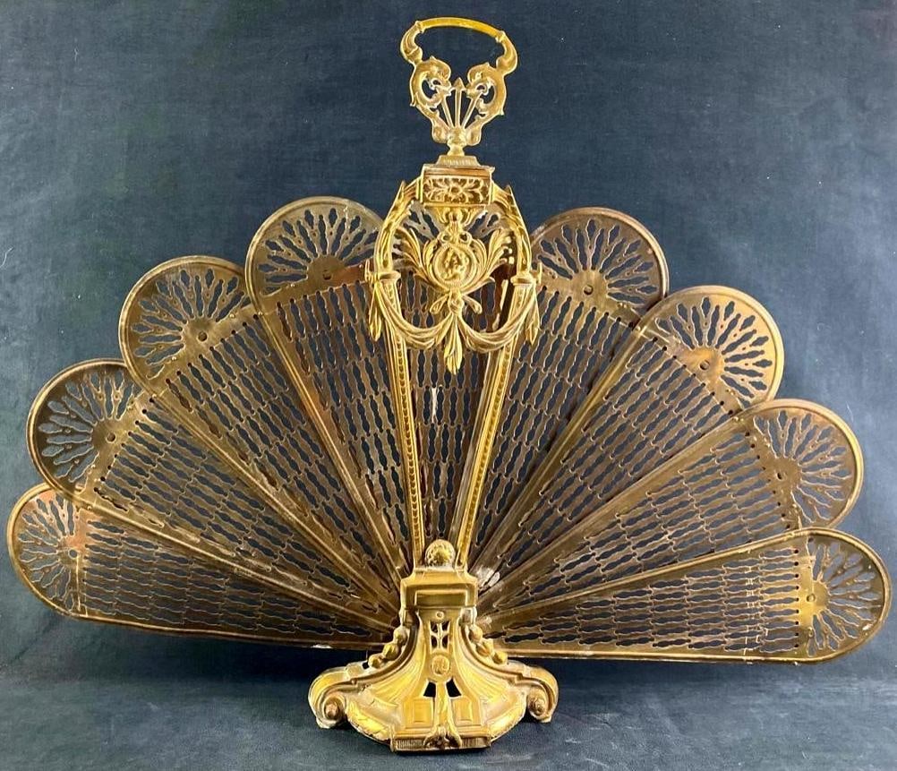 Late 19th Century Peacock Fan Fireplace Screen: Late 19th Century Peacock Fan Fireplace Screen Brass fireplace screen, which when folded out is shaped like a peacock tail or a fan. This piece dates from the Victorian era, and is made of solid bras