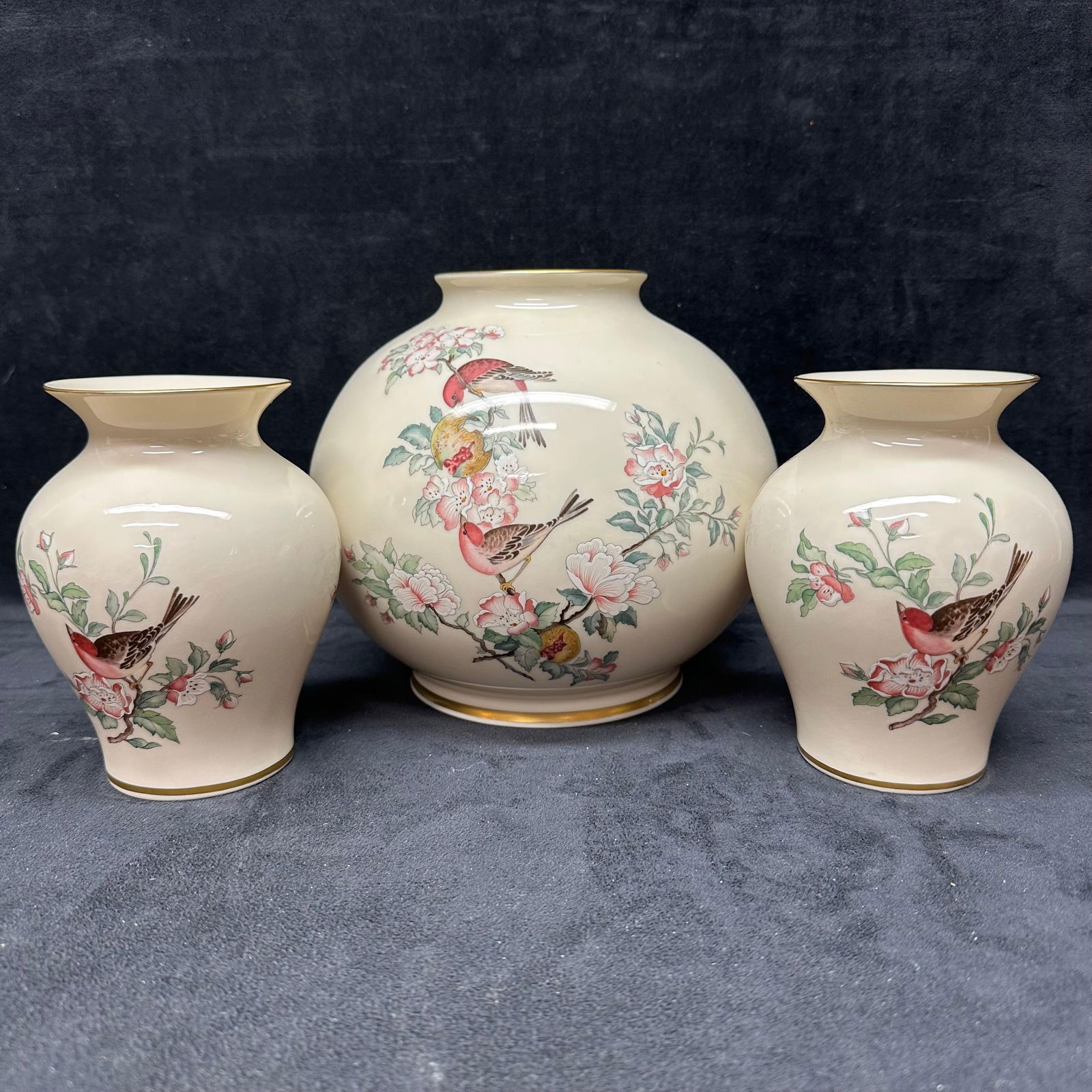 Lenox Serenade Bird and Blossom Porcelain Vase Three Piece Set: Lenox fine ivory porcelain vase set featuring matching bird-and-blossom designs with soft pink, green, and gold accents. Includes one large round vase and two matching bud vases. All pieces marked on