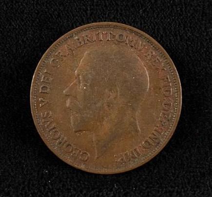 1914 British Penny: 1914 British Penny British copper penny from 1914 featuring King George V on the obverse and Britannia on the reverse. The coin has been circulated, but there is still significant detail on both side
