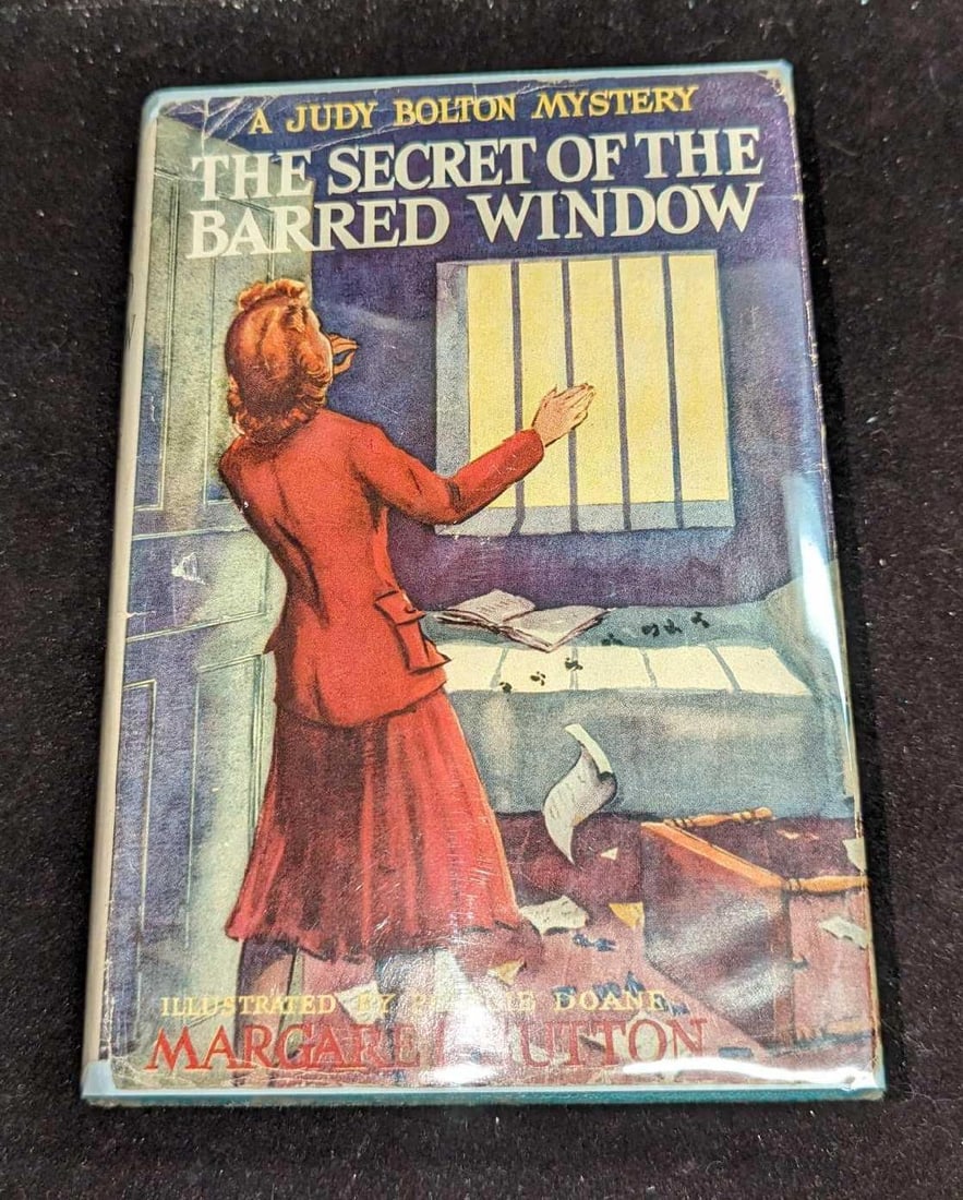 1st Ed Judy Bolton The Secret Of The Barred Window #16: 1st Ed Judy Bolton The Secret Of The Barred Window #16. "A Judy Bolton Mystery - The Secret Of The Barred Window". By Margaret Sutton (The pen name of Rachel Beebe) and was published by Grosset & Dunl