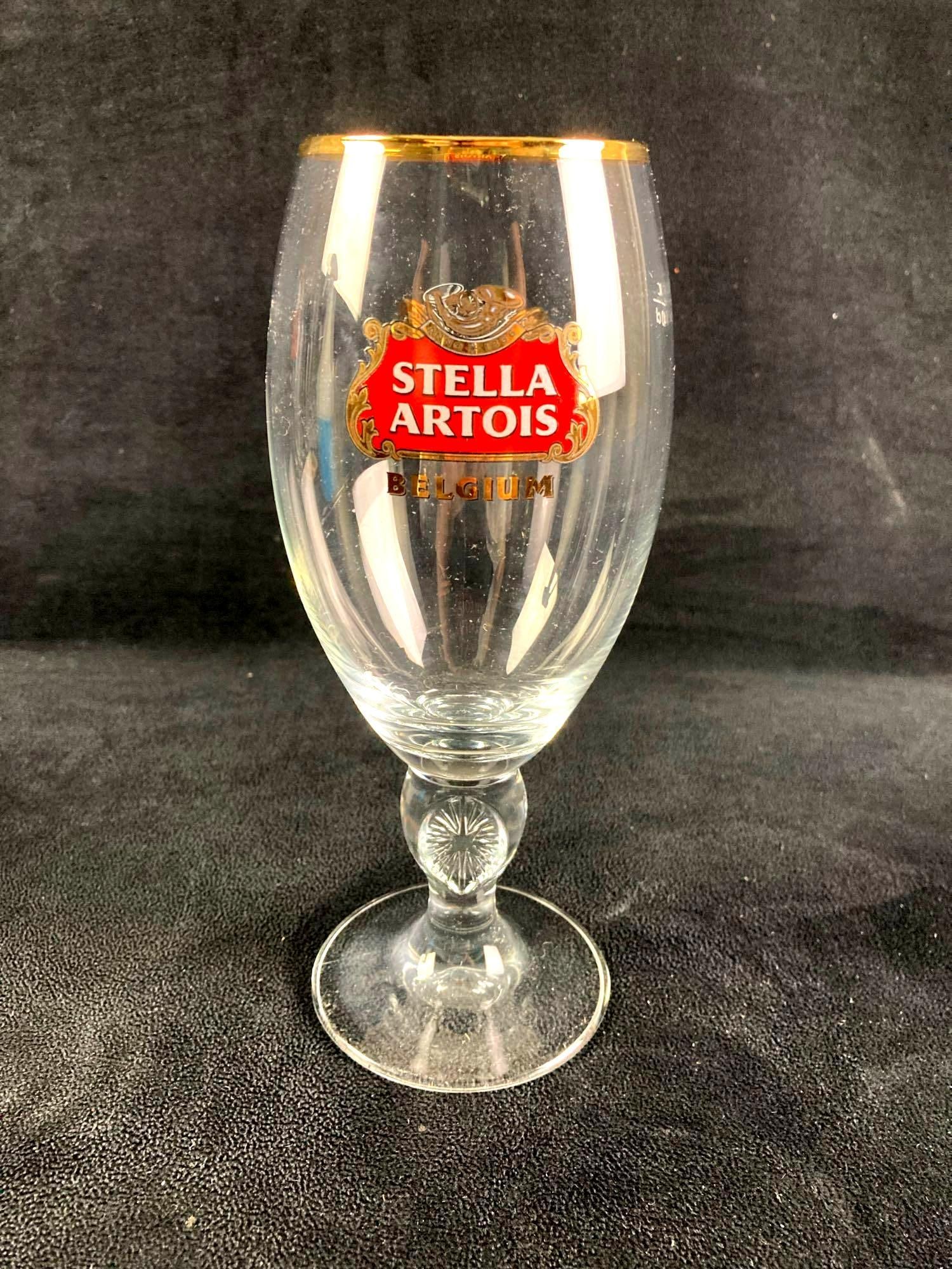 Stella Artois Beer Glass: Up for auction is a recent estate find, a Stella Artois beer glasses ready for drinking. The glasses have the clear Stella Artois logo on the side the gold rim on the top. This auction includes: (1)