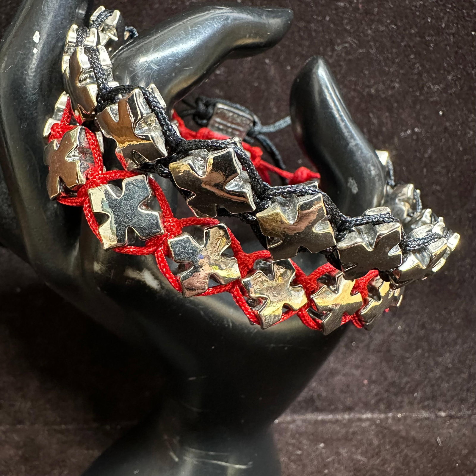 King Baby Studio Silver Tone Crosses Red Black Macrame Braiding Bracelets: Pair of King Baby Studio crosses bracelets featuring multiple cast crosses charm beads strung on braided macrame braiding. One bracelet is red cord, and the other is black cord. Each bracelet has an a