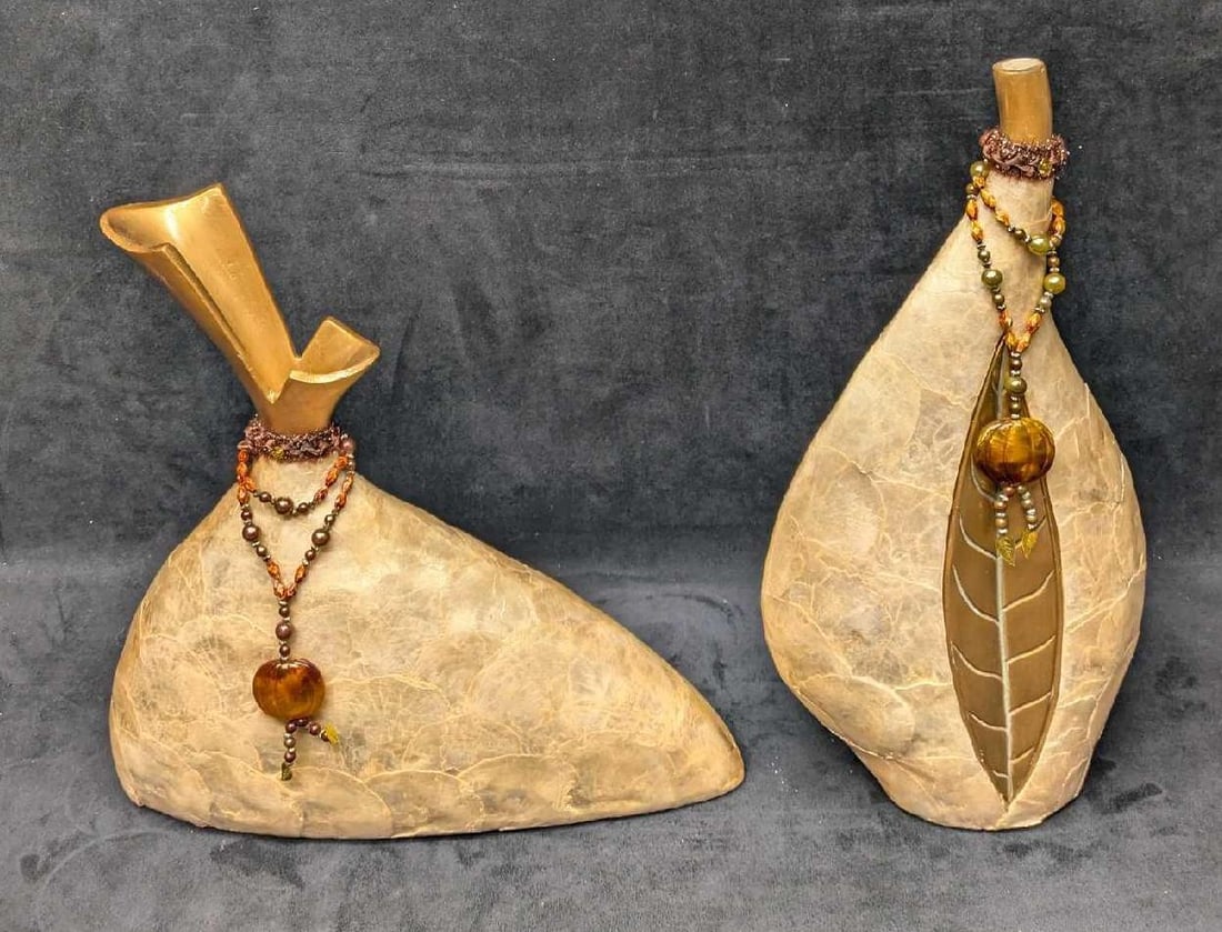 2 Resin Shell Layered Mantel Vases A: 2 Resin Shell Layered Mantel Vases A. This appears to be two resin or plaster vases covered with a shell material. This is suitable for faux flowers. The tall vase is approx 8" x 4" x 16" and it