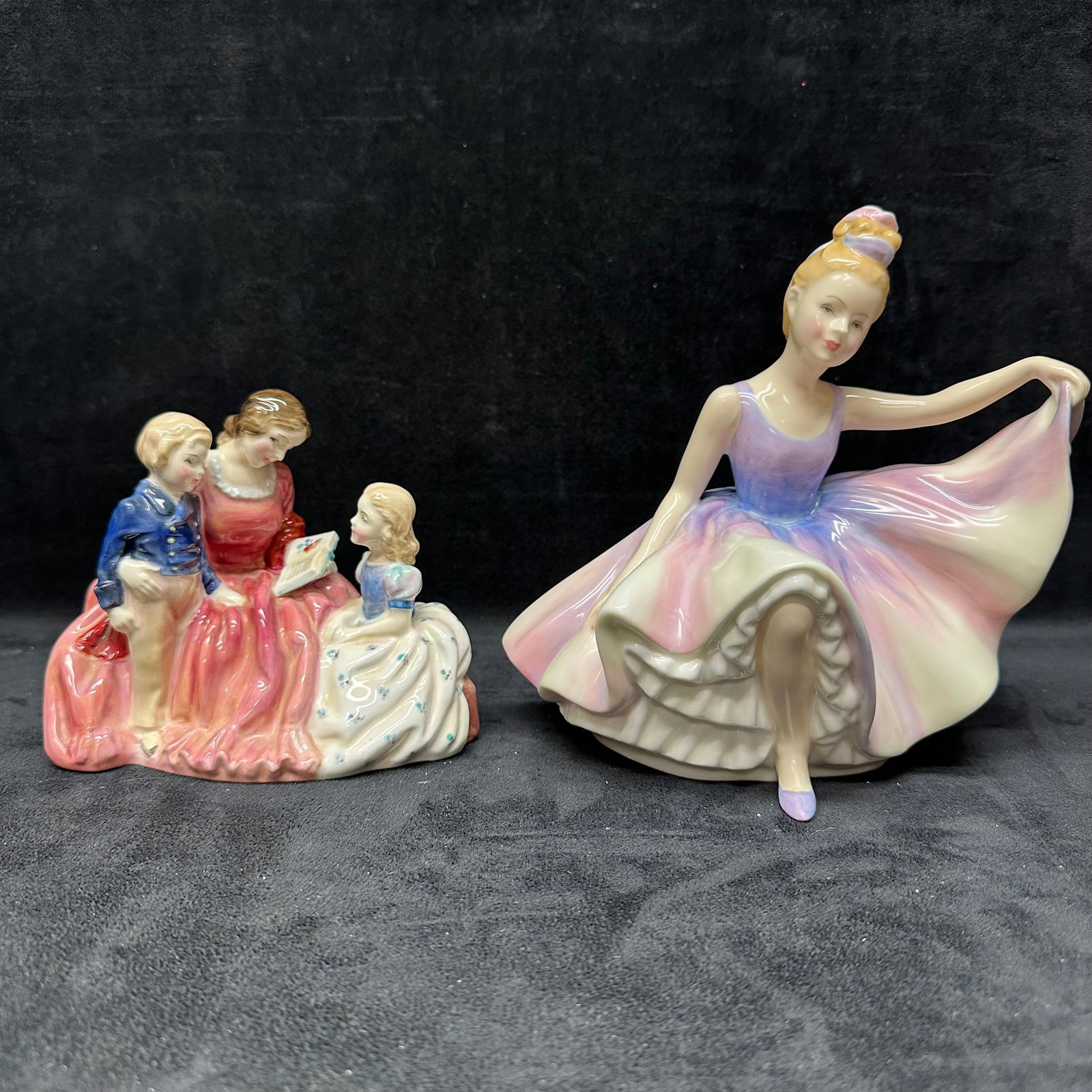 Pair of Royal Doulton Porcelain Figurines Dancing Years and Bedtime Story: Pair of original Royal Doulton hand-painted porcelain figurines. Includes HN 2059 “The Bedtime Story” depicting a seated mother reading with two children, and HN 2235 “Dancing Years”,
