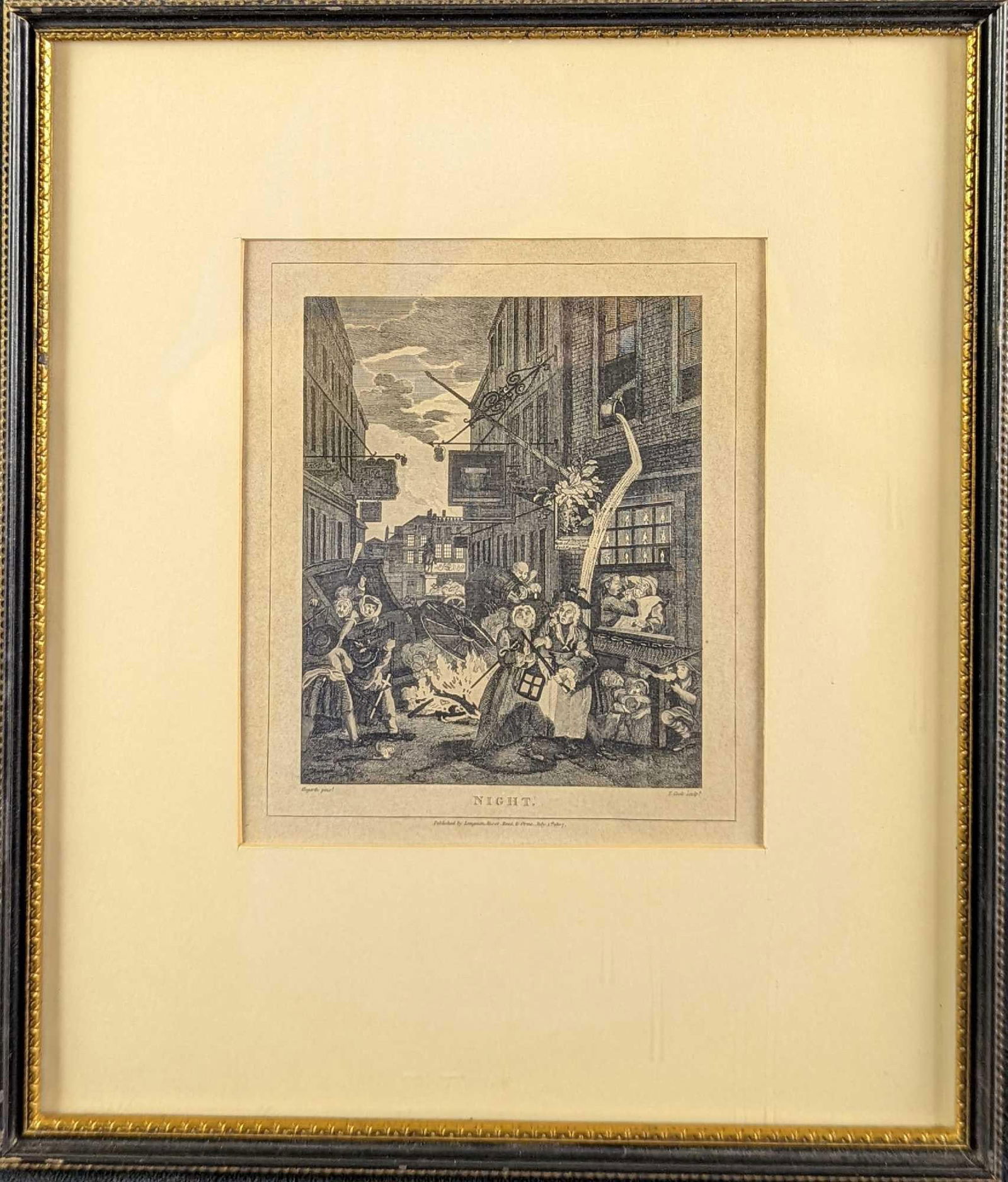 Framed Evening Engraving By T. Cook After W. Hogarth: The print shows the horrors of low life in town, where the statue of Charles I can be seen dimly over a sordid street full of bagnios and quacks. This engraving was published in 1807. The original was
