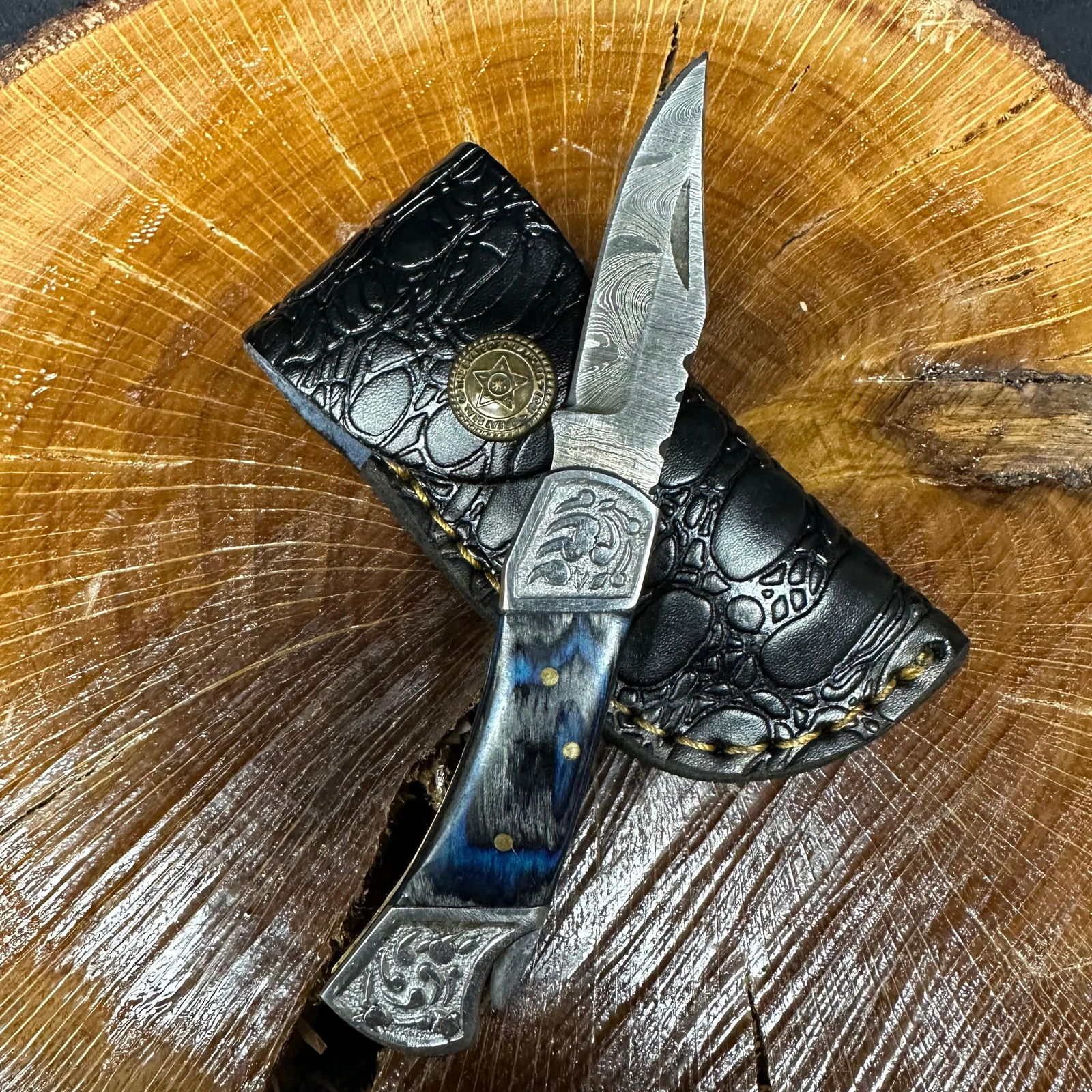 MHS Cutlery Steel Folded Blade Pocket Knife Blue Black Decorative Handle Q92: Folding blade pocket knife by MHS Cutlery featuring a steel blade and decorative spine work. The decorative handle has a contoured, blue/black wood/resin-style grip with metal mosaic pin accents. Incl