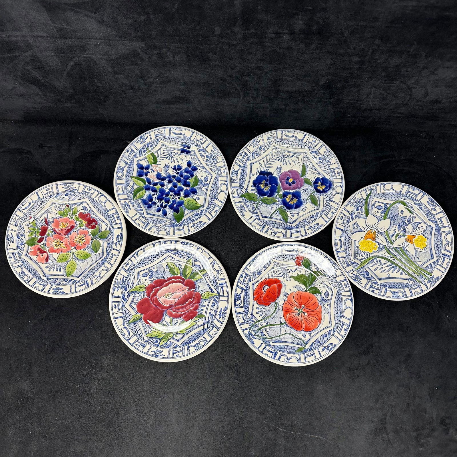 Set of Six Gien France Oiseau Bleu Fleurs Hand Painted French Faience Plates Flowers Floral: Set of six hand-painted faience plates by Gien, France, from the Oiseau Bleu Fleurs Blue Bird Flowers collection. Each plate features a different floral motif, including poppies, roses, pansies, narci