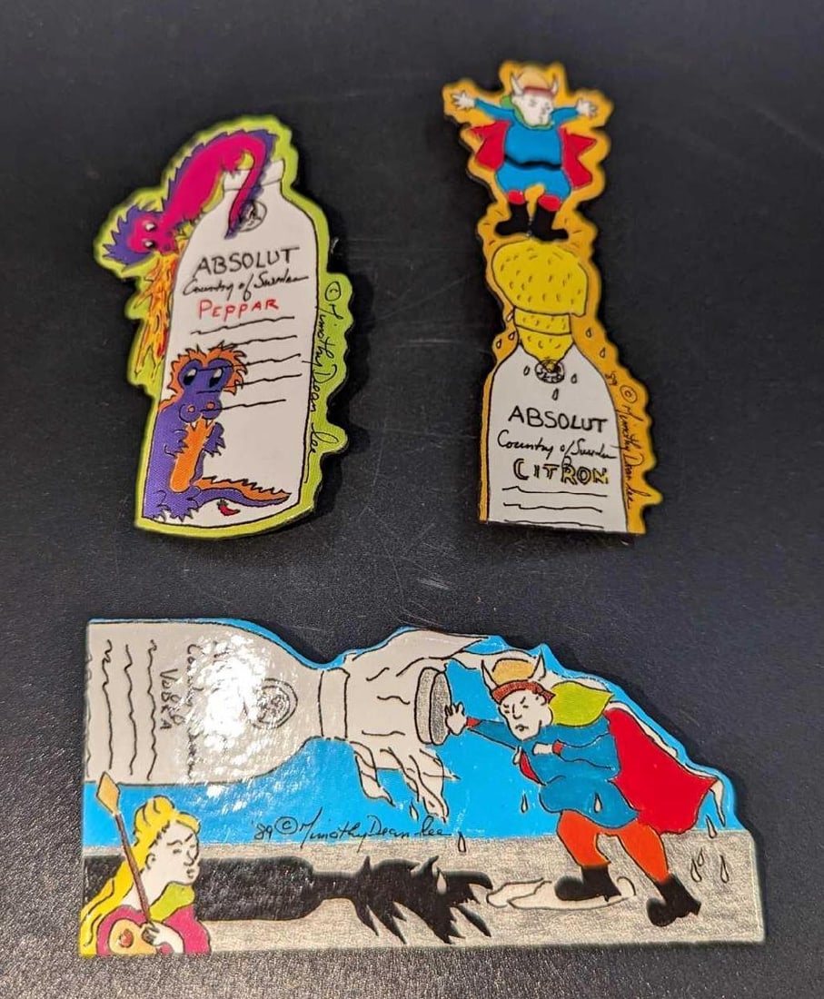 3 Absolut Vodka Peppar Advertising Art Pins / Brooches A: 3 Absolut Vodka Peppar Advertising Art Pins / Brooches A. By Timothy Dean Lee. Each is made of a Laminated Art Board. This was released from the year 1990 to the year 1991. The set is approx 1 5/