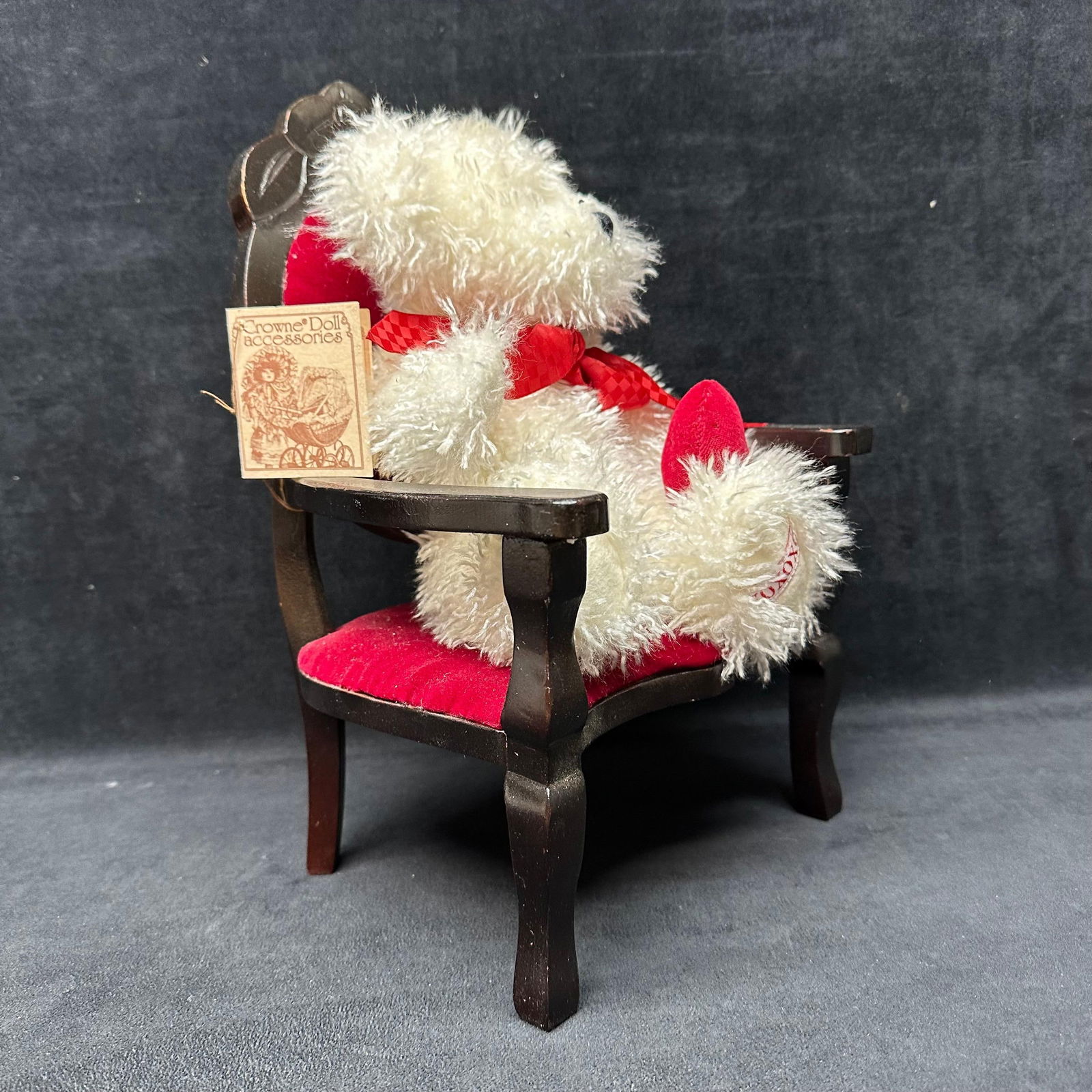 Boyds Bears Plush Teddy with Mini Crowne Doll Accessories Wooden Red Armchair: Boyds Bears plush teddy bear with red ribbon and heart accent, paired with a miniature Crowne Doll Accessories wooden armchair featuring a red upholstered seat. Both pieces retain original tags. Light