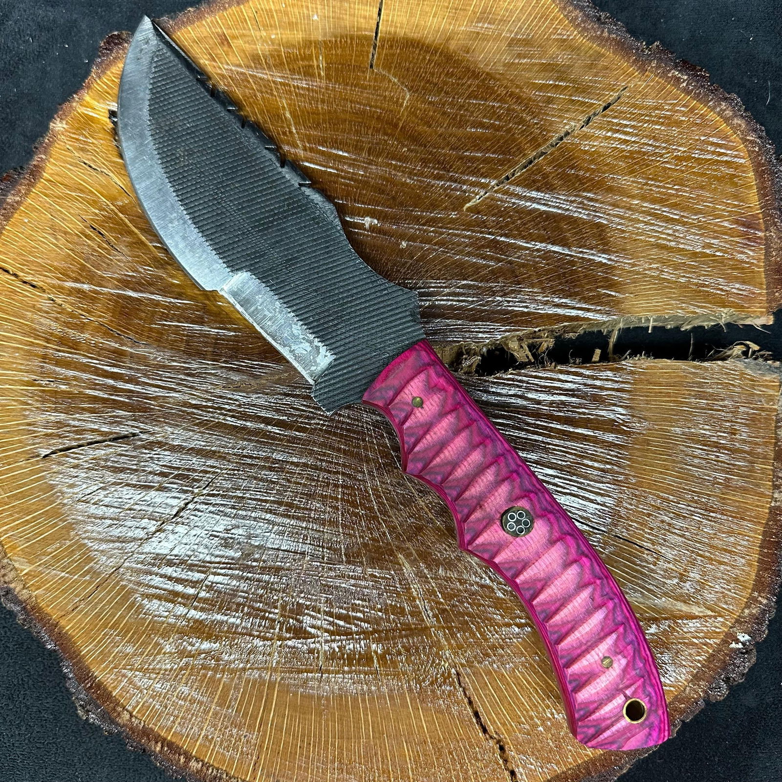 MHS Cutlery Fixed Blade Wooden Pink Handle Knife with Sheath P47: This lot contains an MHS Cutlery Steel Knife. Handcrafted fixed blade knife by MHS Cutlery. Patterned steel blade with visible layered grain. Full tang construction. Handle features a wood grip with a