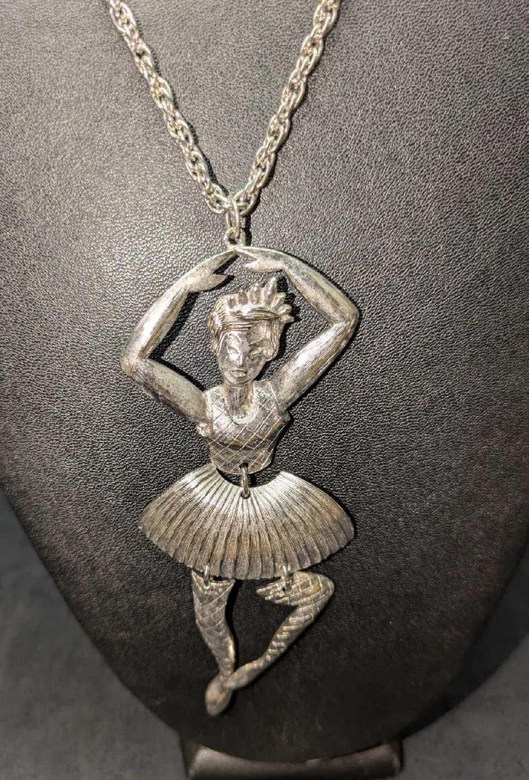 Articulated Silver Tone Jointed Ballerina Pendant And Necklace: Articulated Silver Tone Jointed Ballerina Pendant And Necklace. The necklace is approx 23" and the pendant is approx 2" x 1/8" x 4 1/2". The total weight is 0.11lb. The maker and date of creation is u