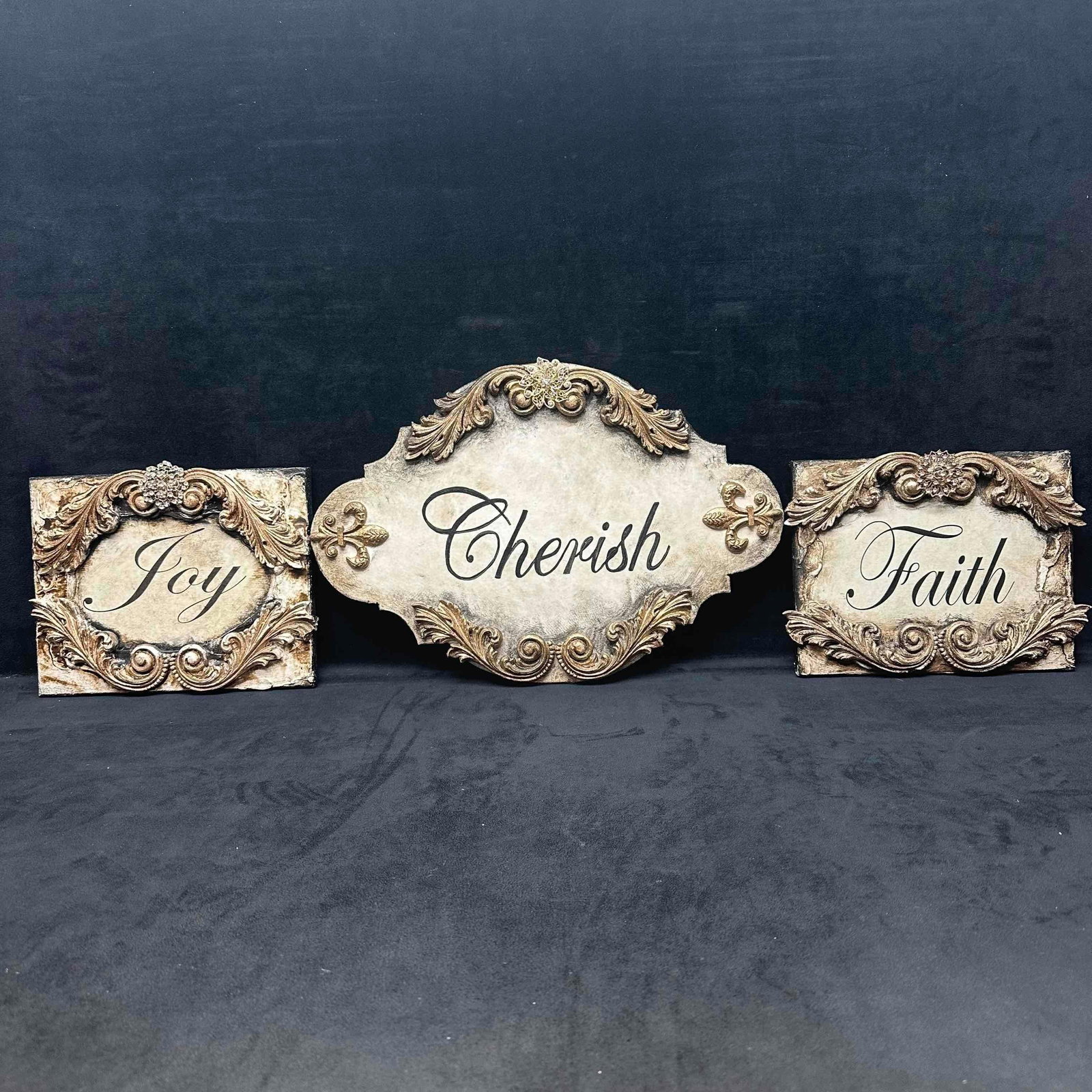 Michelle Butler Designs Joy Faith Cherish Handcrafted Plaque Gold Cream Sign Set: Joy, Faith, and Cherish hand crafted decor pieces with embellished beauty painted by hand in a gorgeous antique cream finish. Minor chips on resin wood decor. Unique plaque hand crafted art pieces fea