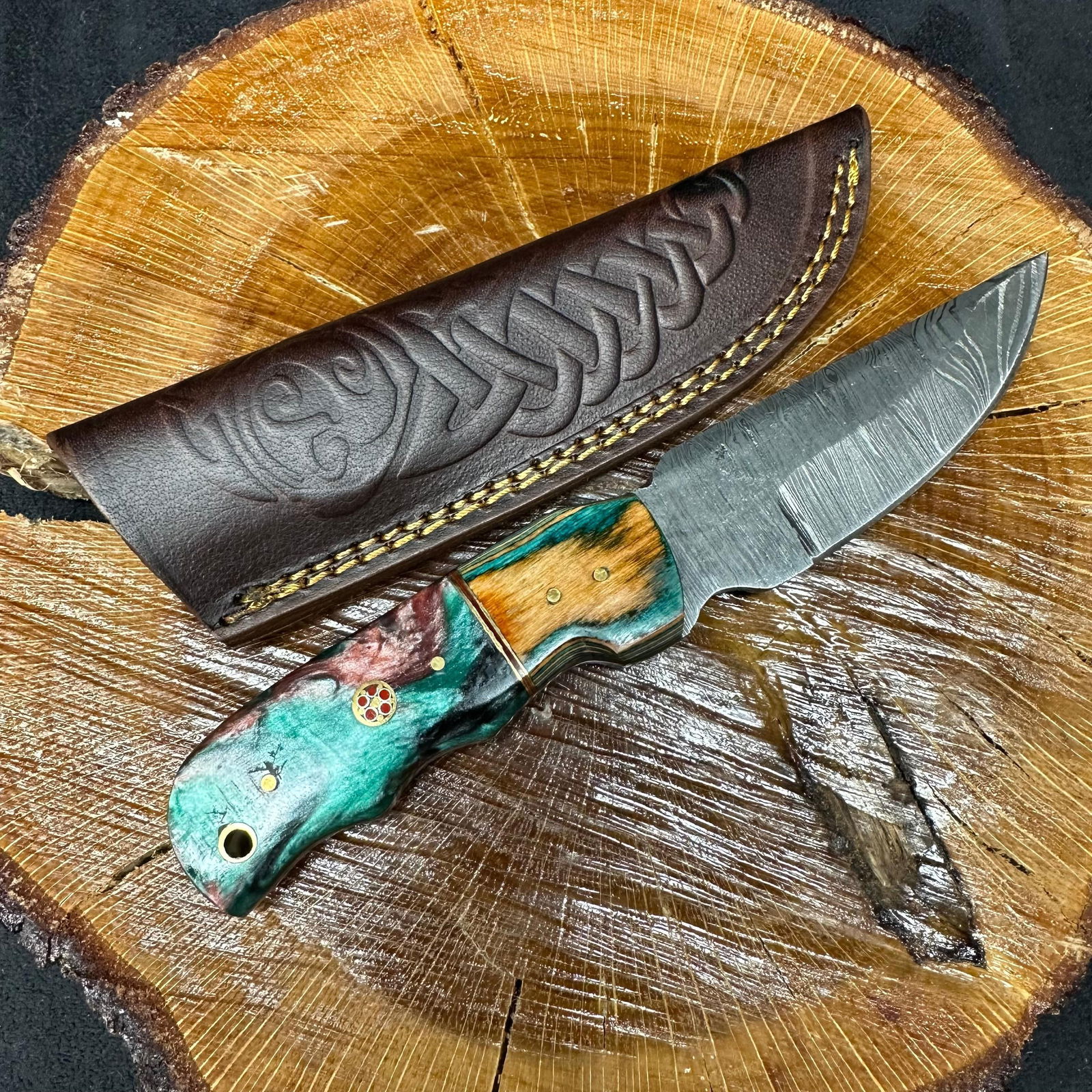 MHS Cutlery Fixed Blade Knife Multi Colored Two Tone Design Handle P85: Fixed blade knife by MHS Cutlery featuring a layered patterned steel blade and decorative spine work. The handle features a contoured, wood/epoxy resin-style grip with two colorway designs with metal