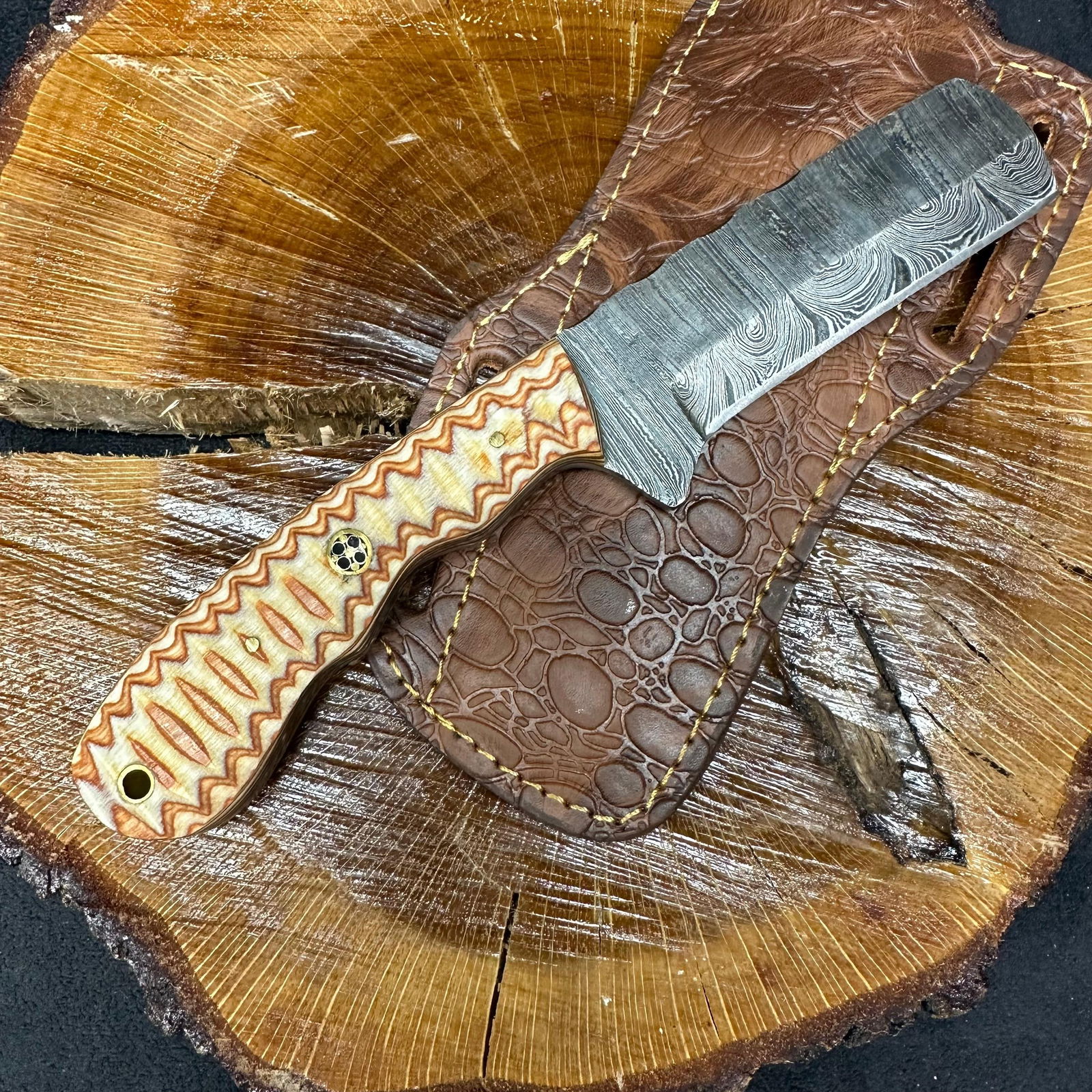Brown and Tan Colorway Handle MHS Cutlery Knife Cleaver Style Blade P96: Fixed small, cleaver-style blade knife by MHS Cutlery featuring a layered patterned steel straight back blade and decorative spine work. The handle features a contoured, wood/epoxy resin-style grip wi