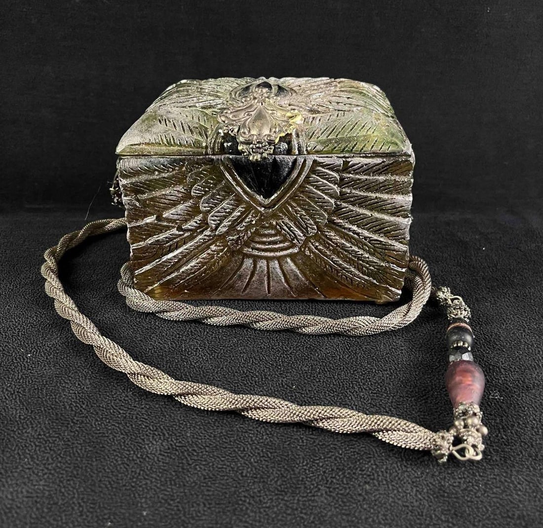 Maya Evangelista Handmade Chest Purse Rare: Maya Evangelista Handmade Chest Purse Rare pictured is a Maya Evangelista resin purse in teh shape of a chest with intricate feather designs around it. Circa mid-1980s. Made from the resin of trees i
