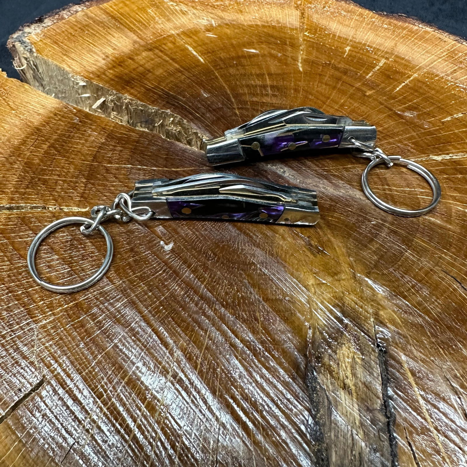 MHS Cutlery Keychain Steel Blade Pocket Knife Purple Set R47: Small key chain-sized folding-blade pocket knife set featuring steel blades and a compact epoxy-resin/wood purple handle secured with brass pins. Includes an attached metal key ring for easy carry. Tw