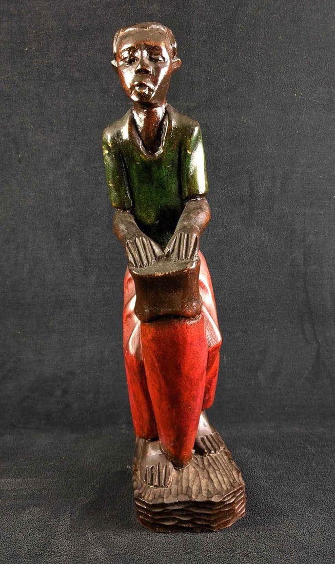 Wood Carved African Man Sculpture with Drum: Wood Carved African Man Sculpture with Drum This sculpture is of a man playing what looks like a drum. This sculpture has a few scratches. The sculpture has a clear glossy coat protecting the wood and