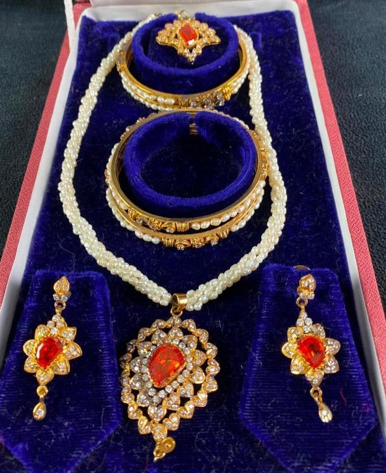 Vintage Gold-Plated Indian Wedding Jewelry: Vintage Gold-Plated Indian Wedding Jewelry Indian wedding jewelry set, gold plated with crystal imitation stones. The necklace and bracelets incorporate small river pearls. In good condition, with