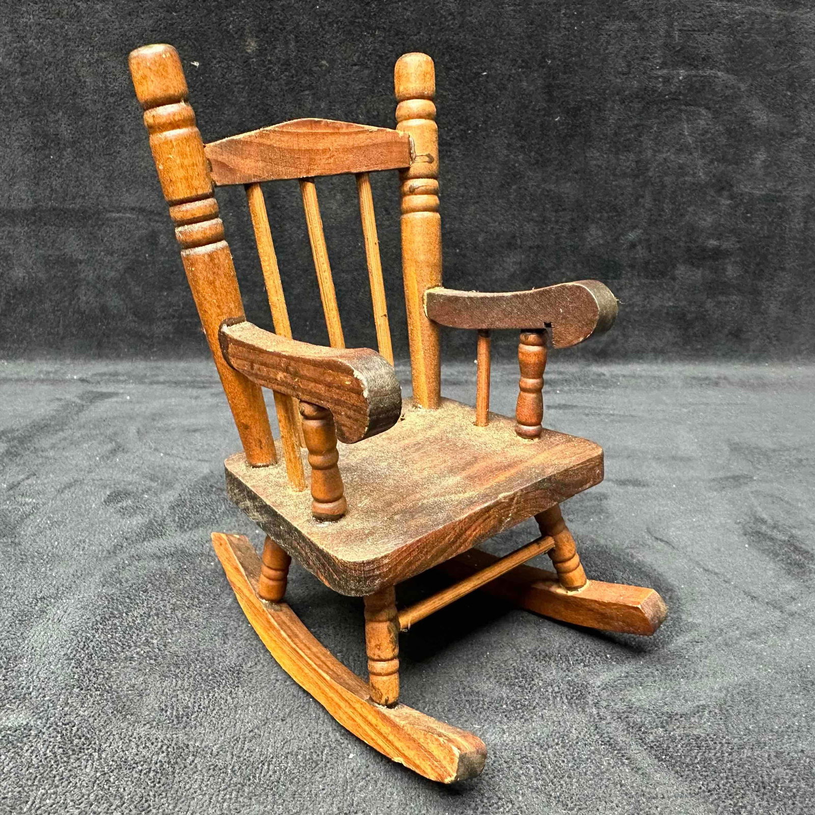 Wooden Miniature Rocking Chair Rustic Folk Art Doll Furniture: Vintage miniature wooden rocking chair, featuring a classic spindle back design and turned arm supports. This small-scale piece is perfect for displaying with dolls, teddy bears, or as a decorative ac