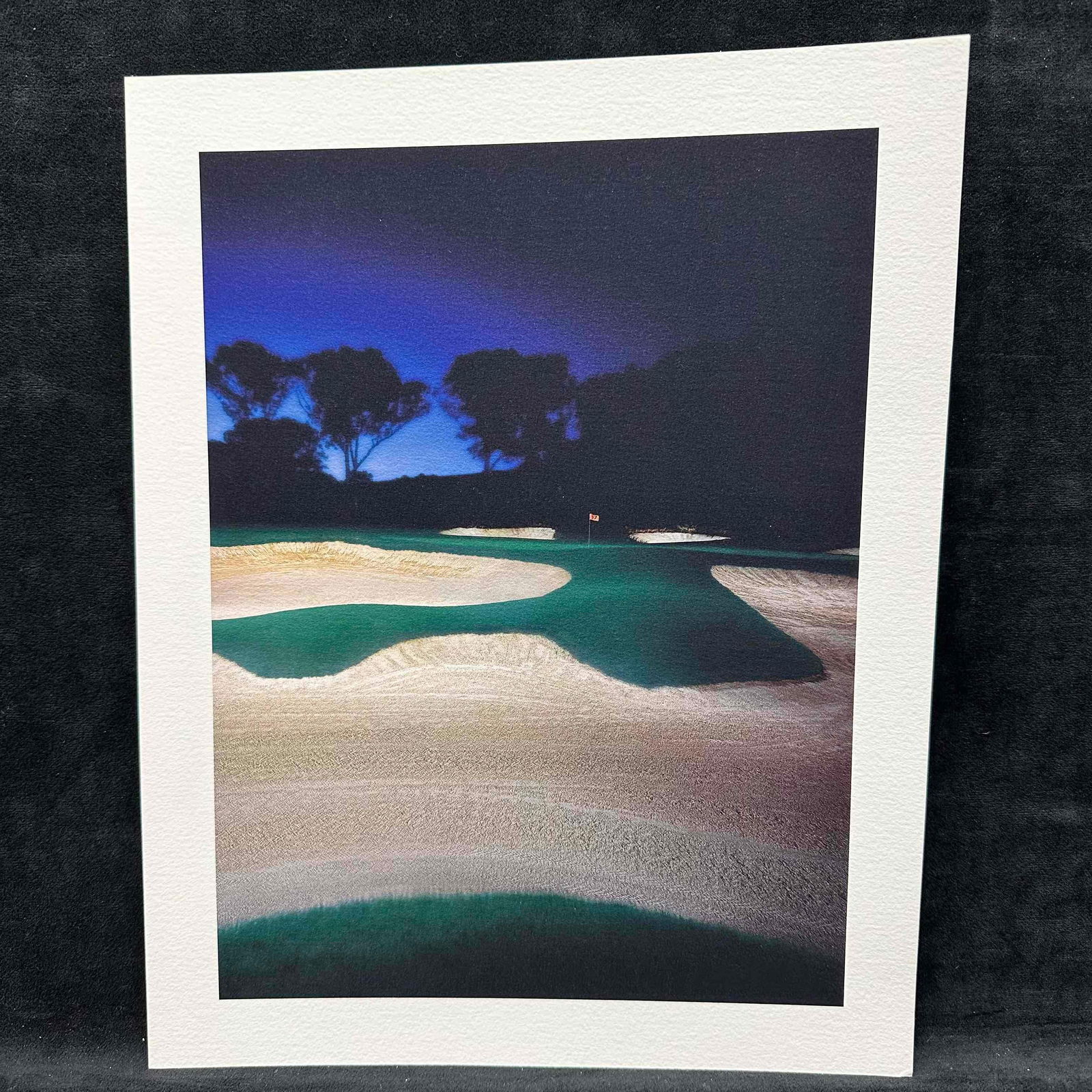 Fine Art Print Lithograph Golf Course Nightscape Bunker and Green Scene GC2: Beautiful high-quality lithograph print featuring a striking nighttime view of a golf course green surrounded by bunkers. The scene captures the dramatic contrast of the dark tree line and glowing gre