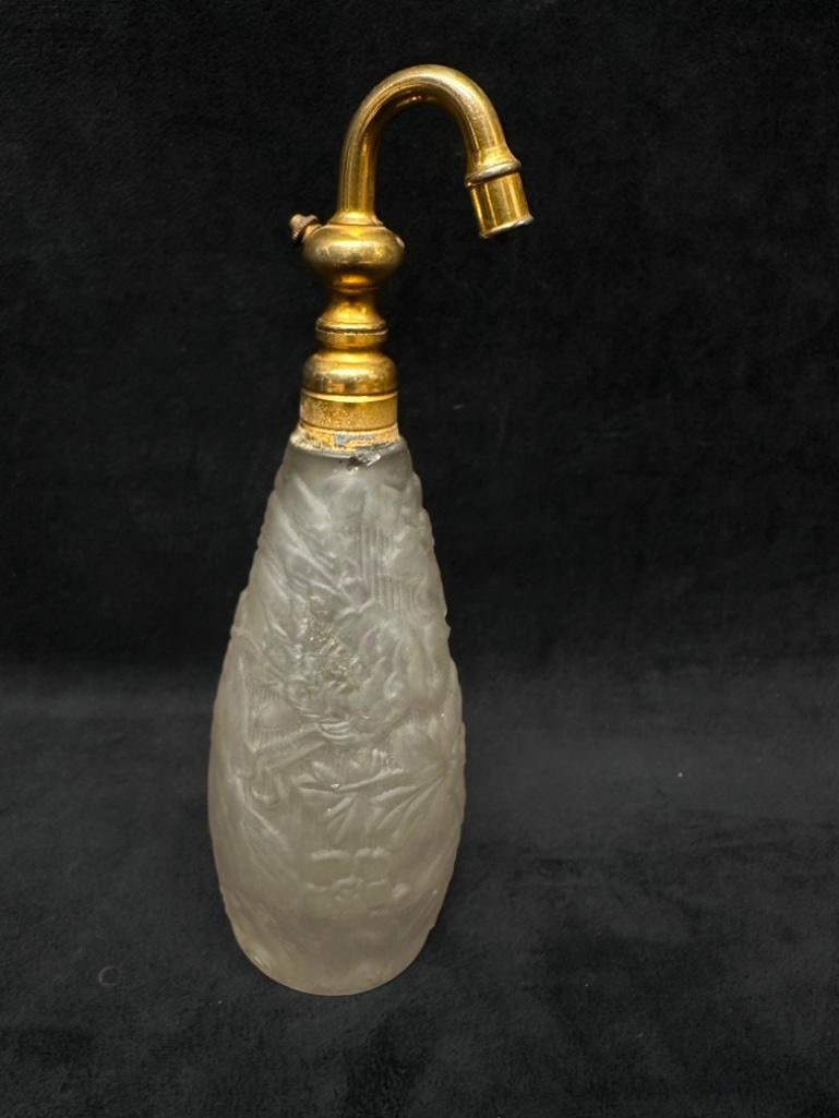 Antique Frosted Glass Floral Perfume Atomizer: Antique Frosted Glass Floral Perfume Atomizer Perfume atomizer in clear frosted glass, with 3-D floral pattern on the outside. Has an unidentified mark on the bottom that may be a maker's mark. A
